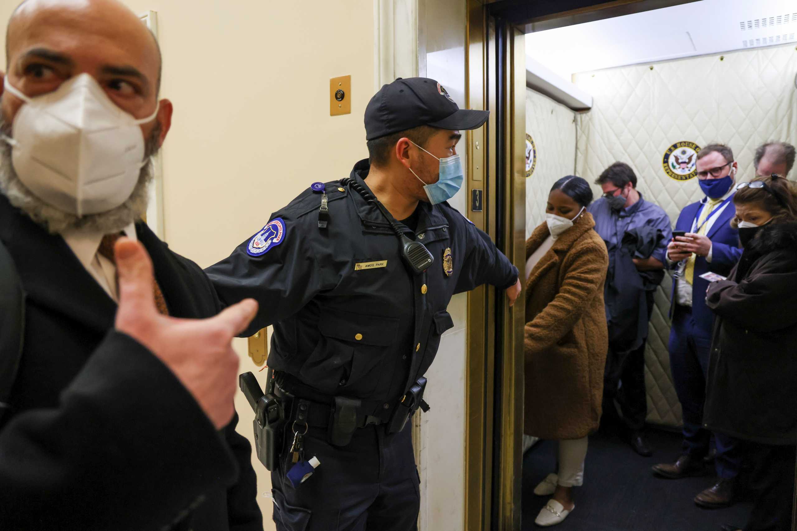 U.S. Capitol Police evacuate journalists and House press staff members from the Capitol to a connected office building, in Washington, U.S., January 6, 2021. REUTERS