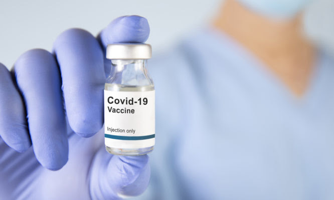 Doctor or lab technician holding vaccine of new coronavirus