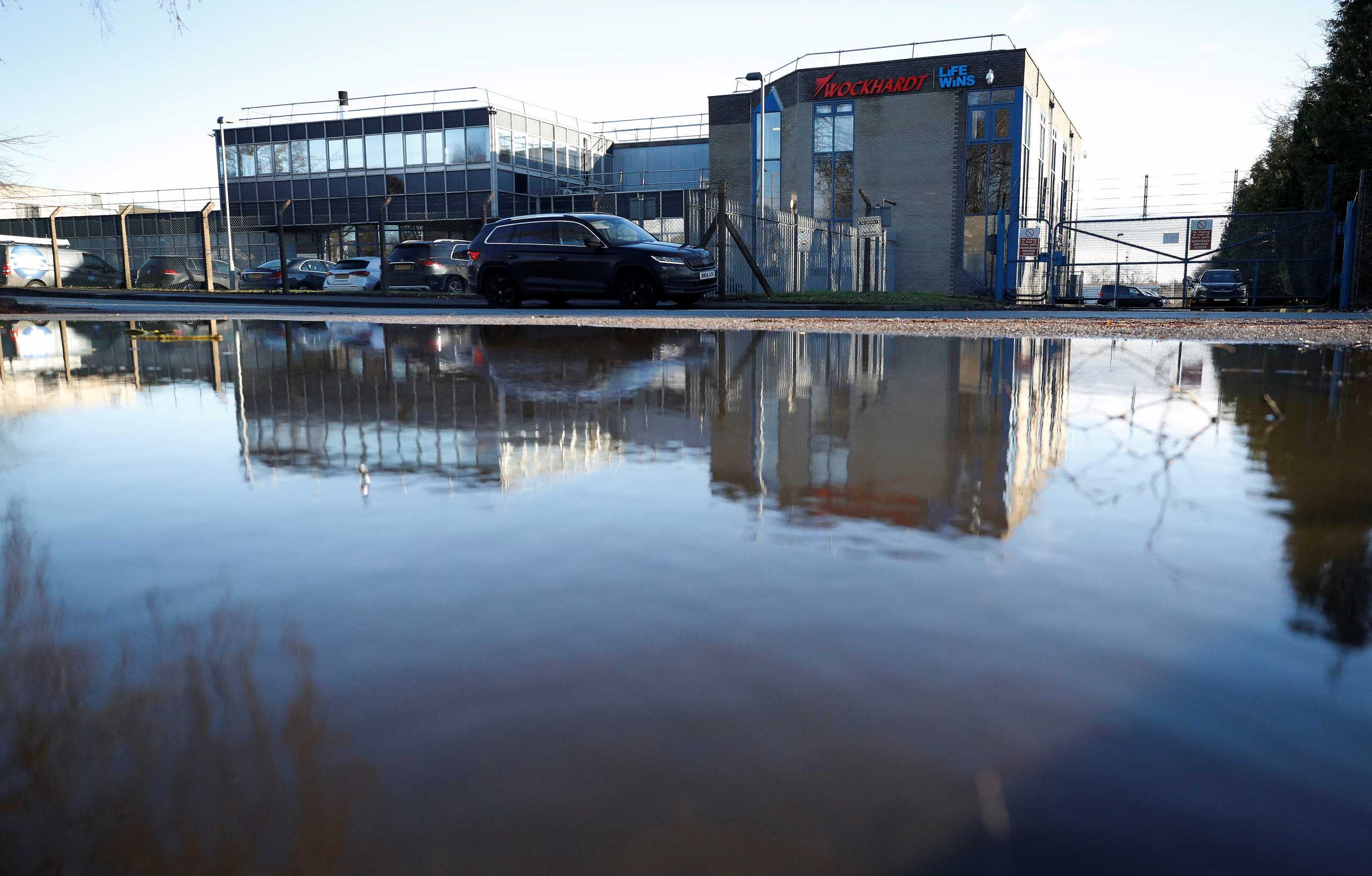 The Wockhardt pharmaceutical plant is reflected in a puddle in Wrexham, Britain January 21, 2021. REUTERS