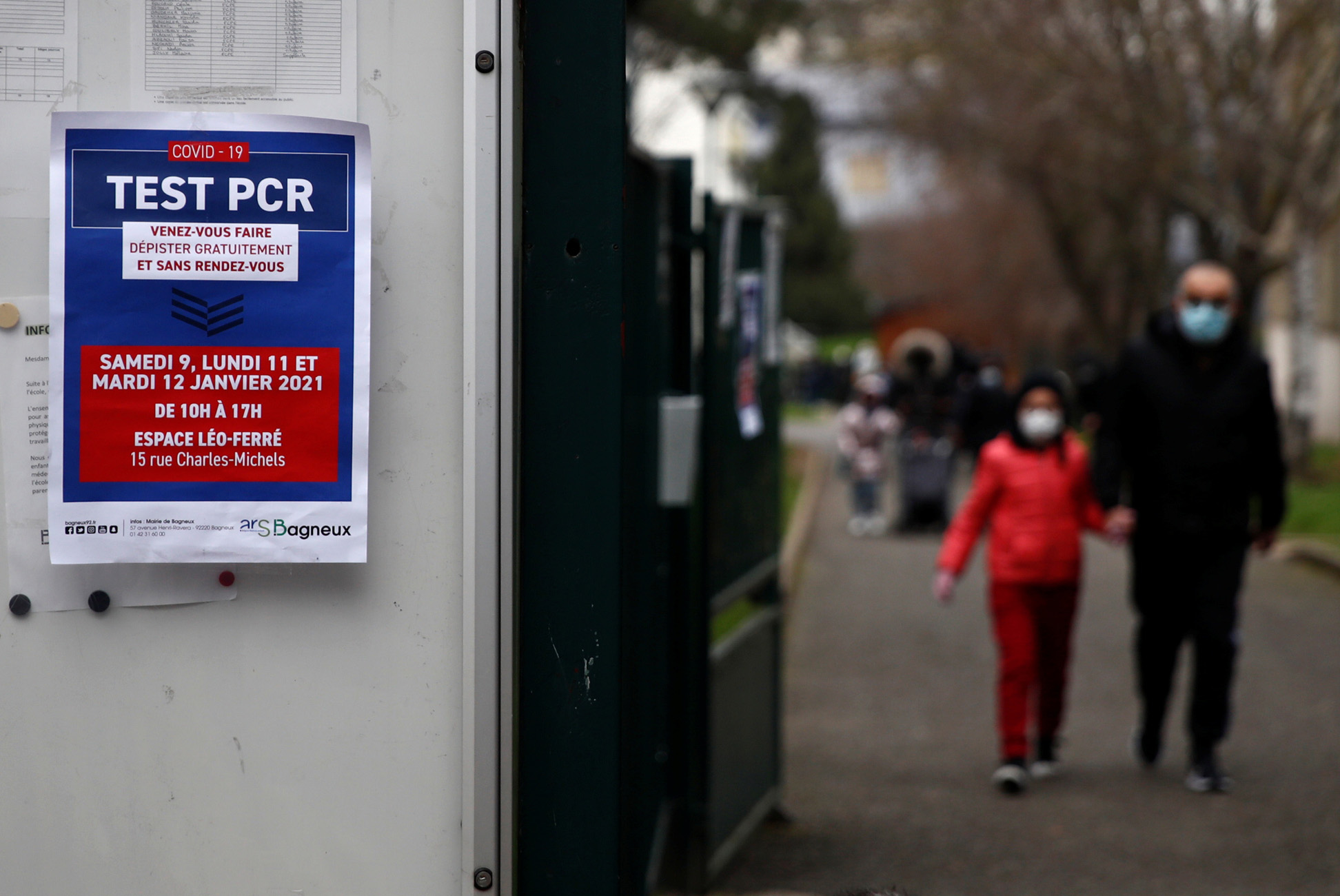 A placard which reads "Covid-19 PCR test : come and get tested for free and without an appointment" is seen at the elementary school Maurice Thorez in Bagneux, France, January 8, 2021. REUTERS