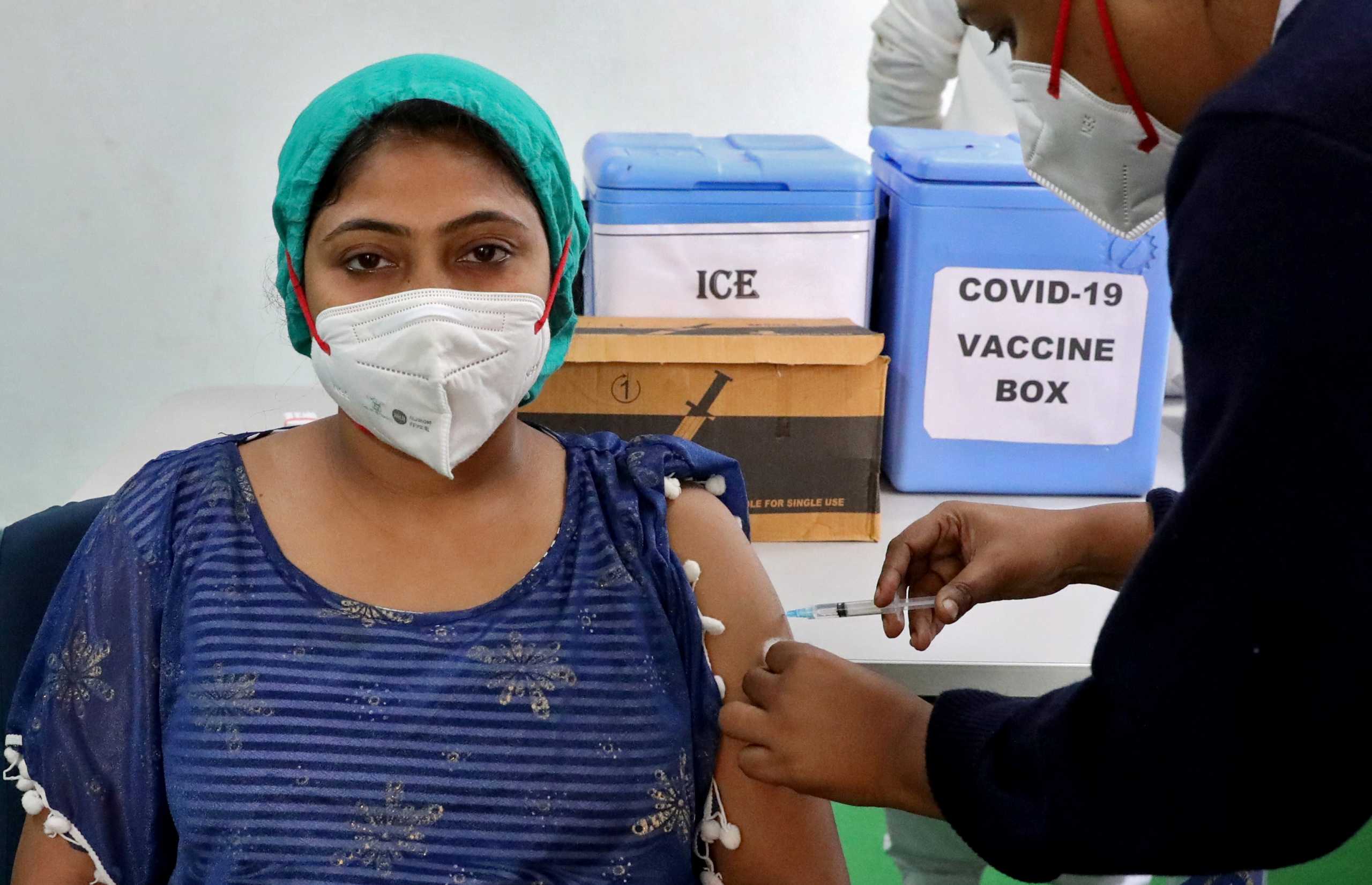 A healthcare worker receives a dose of COVISHIELD, a COVID-19 vaccine manufactured by Serum Institute of India, at a government-run hospital at Baruipur on the outskirts of Kolkata, India, January 18, 2021. REUTERS