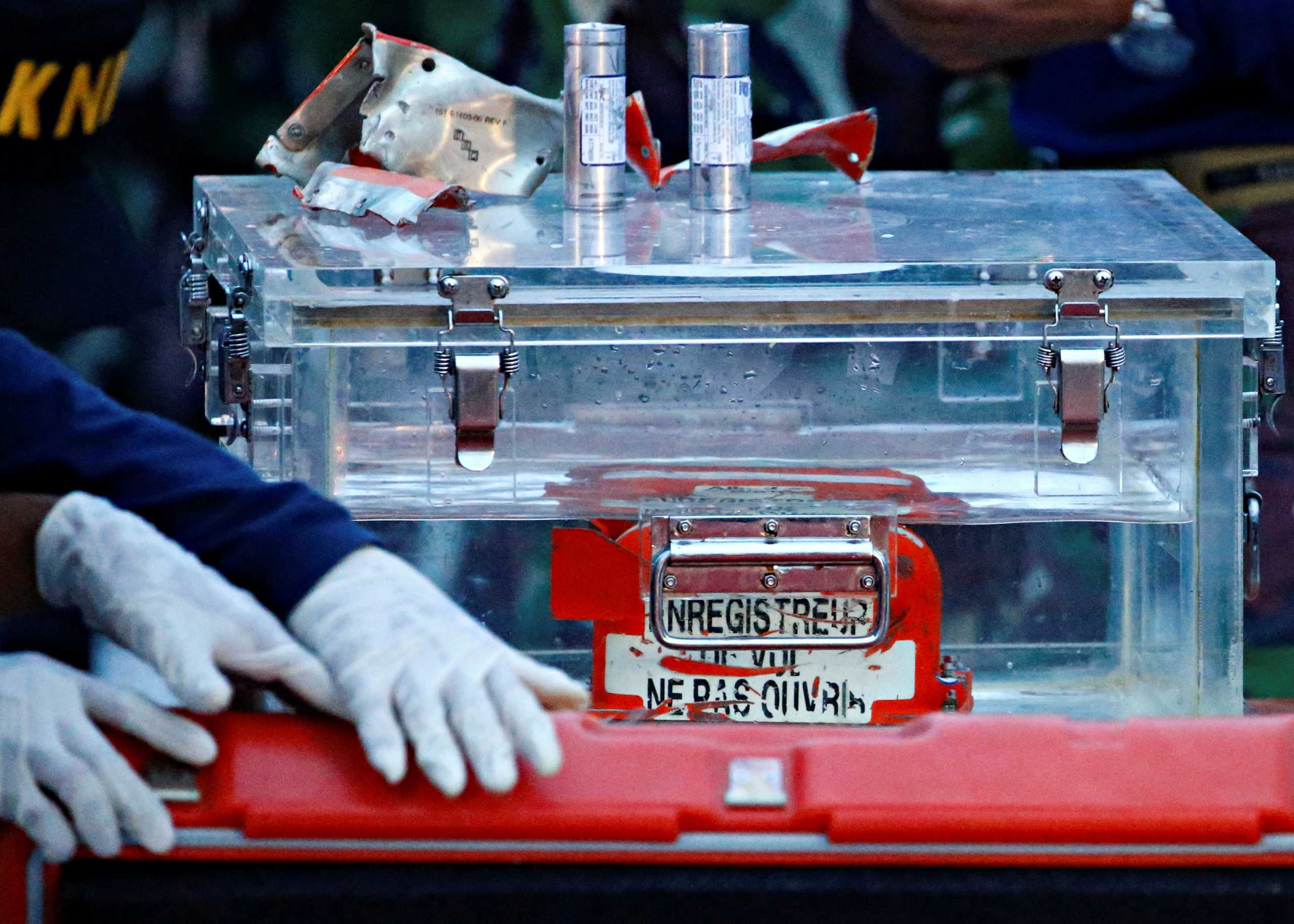 FILE PHOTO: A National Transportation Safety Committee (KNKT) official holds a part of the retrieved black box of Sriwijaya Air flight SJ 182, which crashed into the sea at the weekend off the Jakarta coast, in Jakarta, Indonesia, January 12, 2021. REUTERS