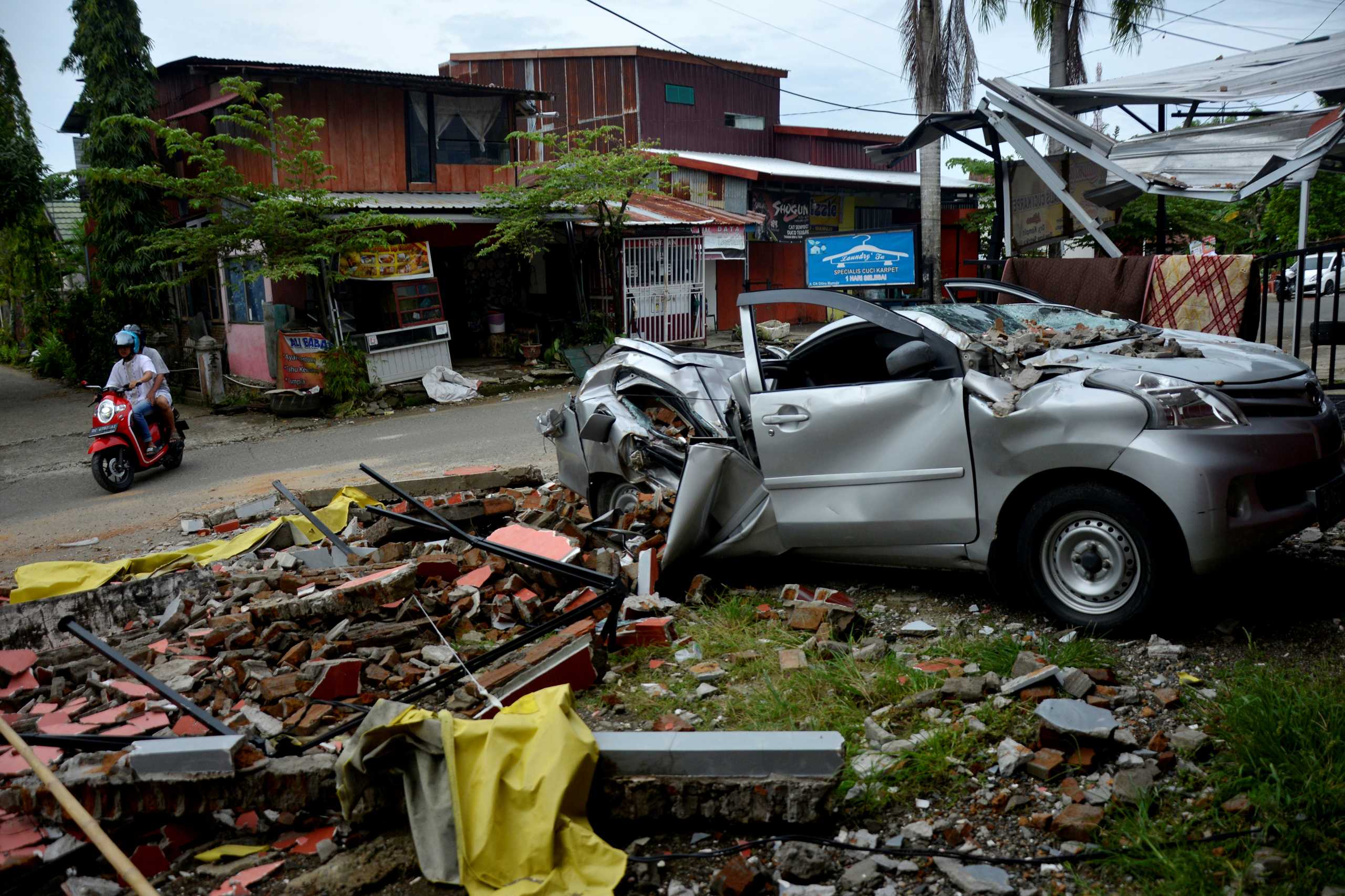 A damaged car is seen among the ruins following an earthquake in Mamuju, West Sulawesi province, Indonesia, January 17, 2021. Abriawan Abhe