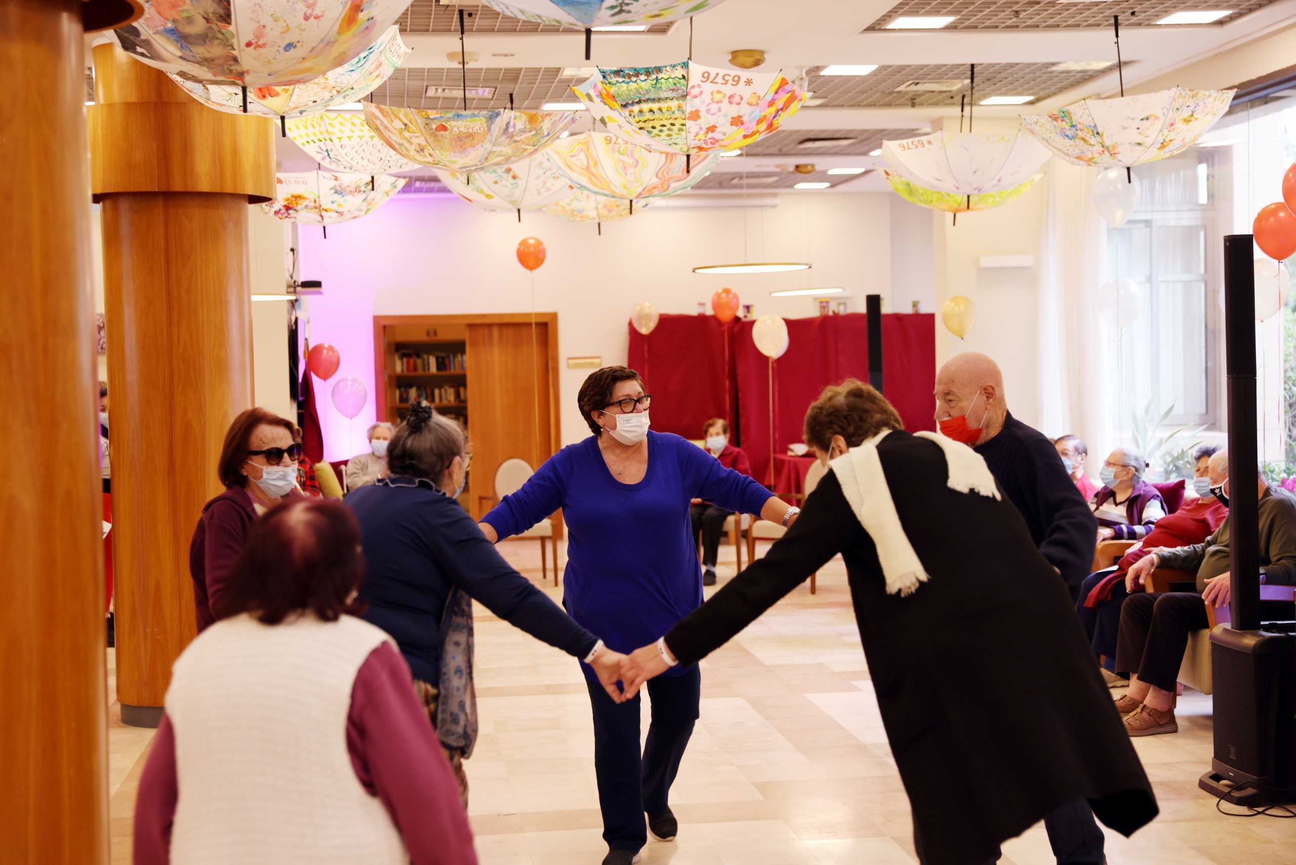 Residents of an assisted living facility dance after receiving their booster shot of the vaccination against the coronavirus disease (COVID-19) during a party celebrating the residents receiving their second dose of the vaccine, in Netanya, Israel January 19, 2021. REUTERS