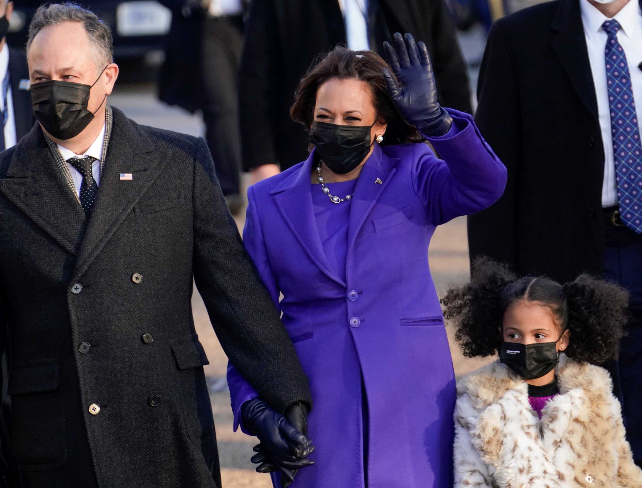 U.S. Vice President Kamala Harris and her husband Douglas Emhoff salutes as they walk during the Inauguration Day parade for U.S. President Joe Biden, in Washington, U.S., January 20, 2021. REUTERS
