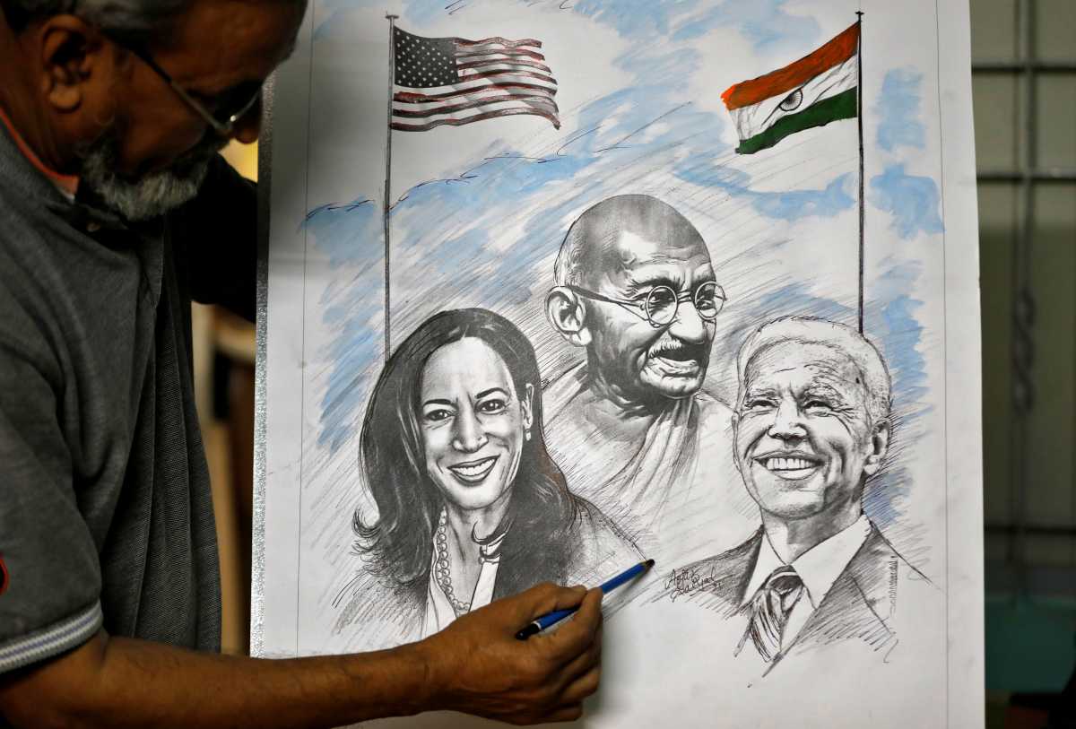 Aejaz Saiyad, an artist, gives finishing touches to a drawing of U.S. President-elect Joe Biden, Vice President-elect Kamala Harris and India's independence hero Mahatma Gandhi at his home in Ahmedabad, India, January 20, 2021. REUTERS