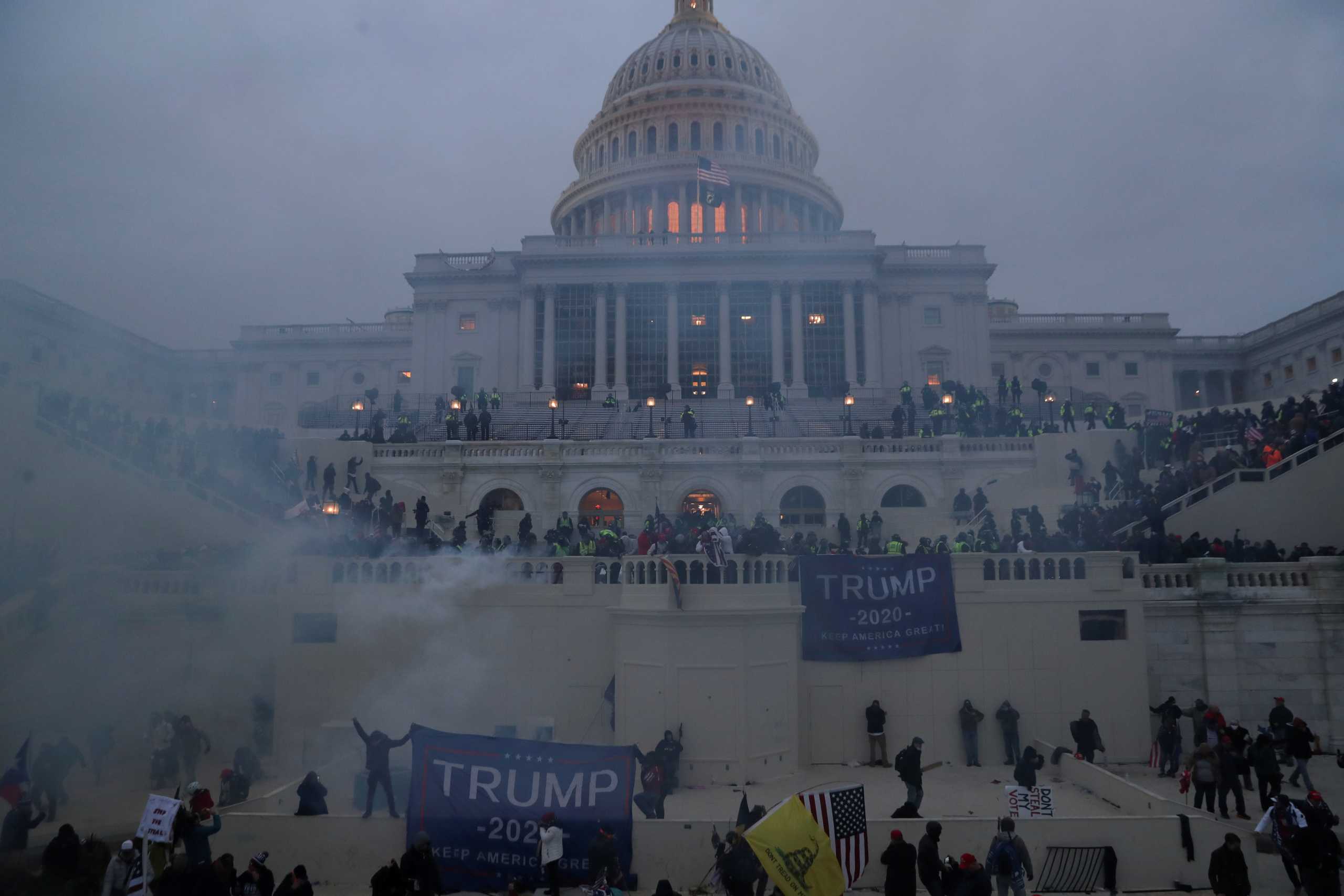 Police officers stand guard as supporters of U.S. President Donald Trump gather in front of the U.S. Capitol Building in Washington, U.S., January 6, 2021. REUTERS