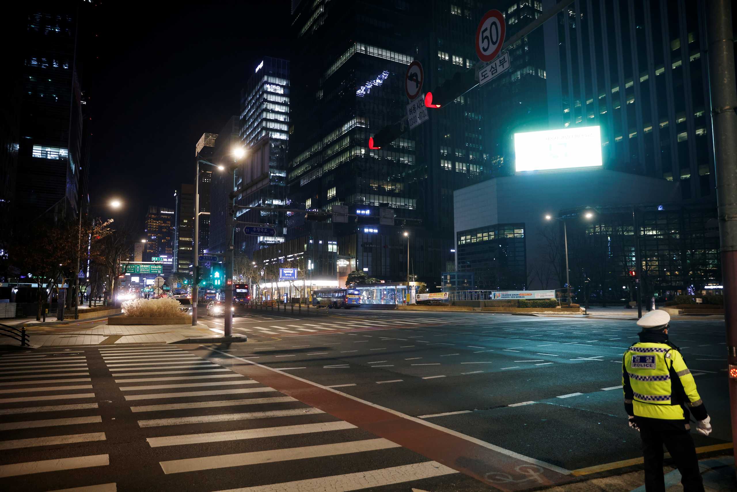 A policeman stands before a zebra crossing on New Year's Eve amid the coronavirus disease (COVID-19) pandemic in Seoul, South Korea, December 31, 2020. REUTERS