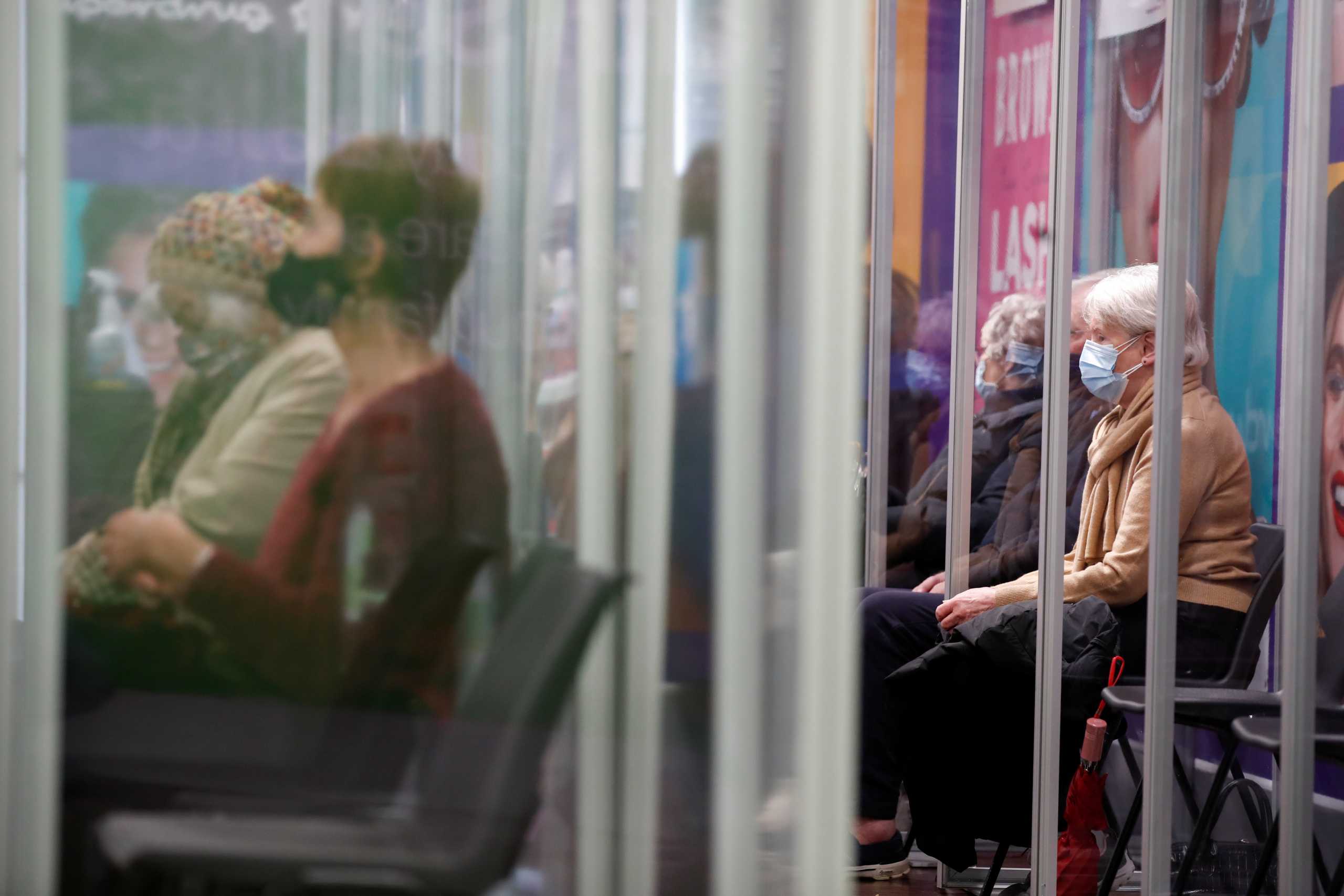People wait to receive the Oxford