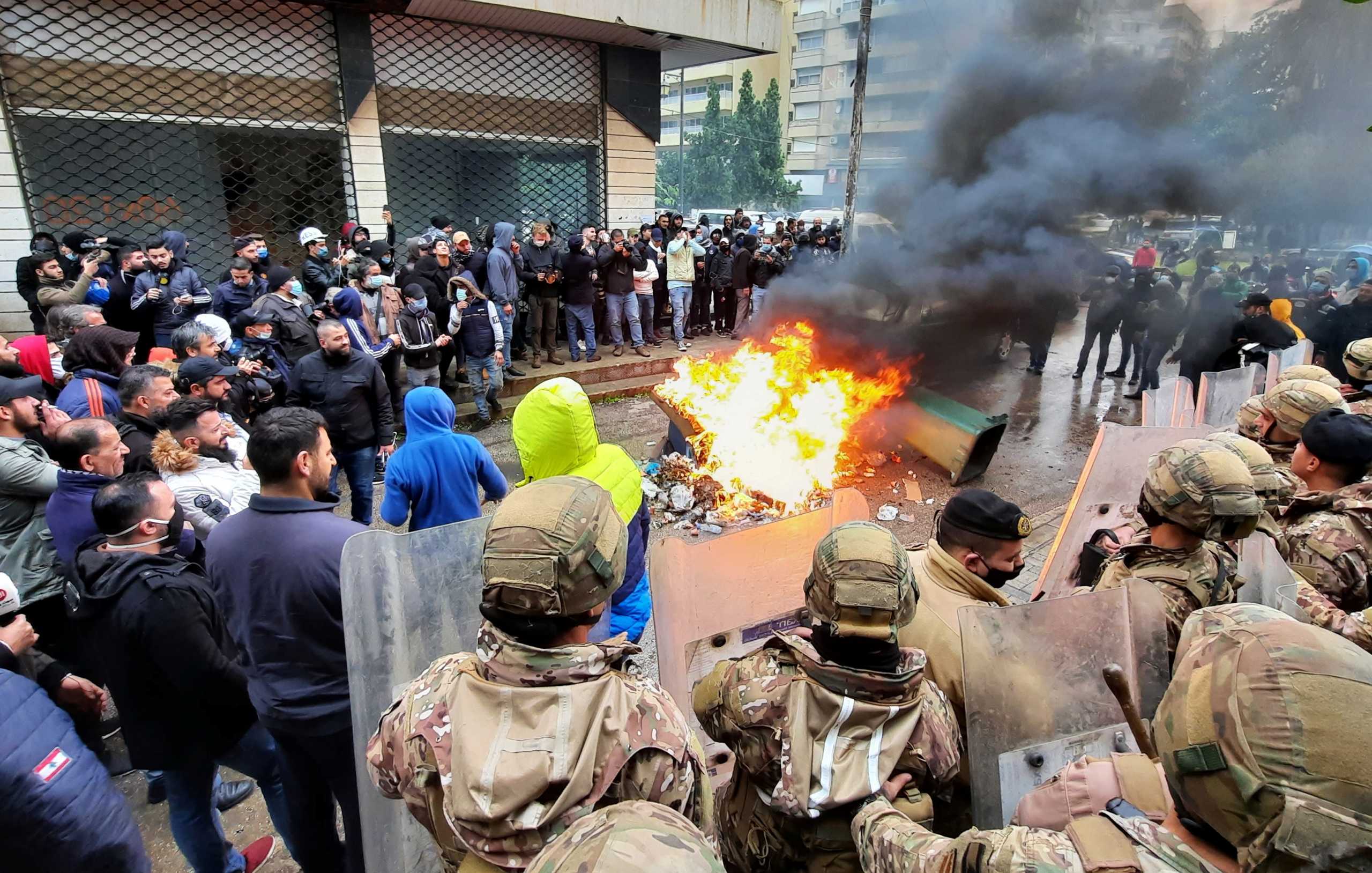 Army soldiers stand guard as demonstrators set fire near a Lebanese politician's house, during a protest against the lockdown and worsening economic conditions amid the spread of the coronavirus disease (COVID-19), in Tripoli, Lebanon January 28, 2021. REUTERS