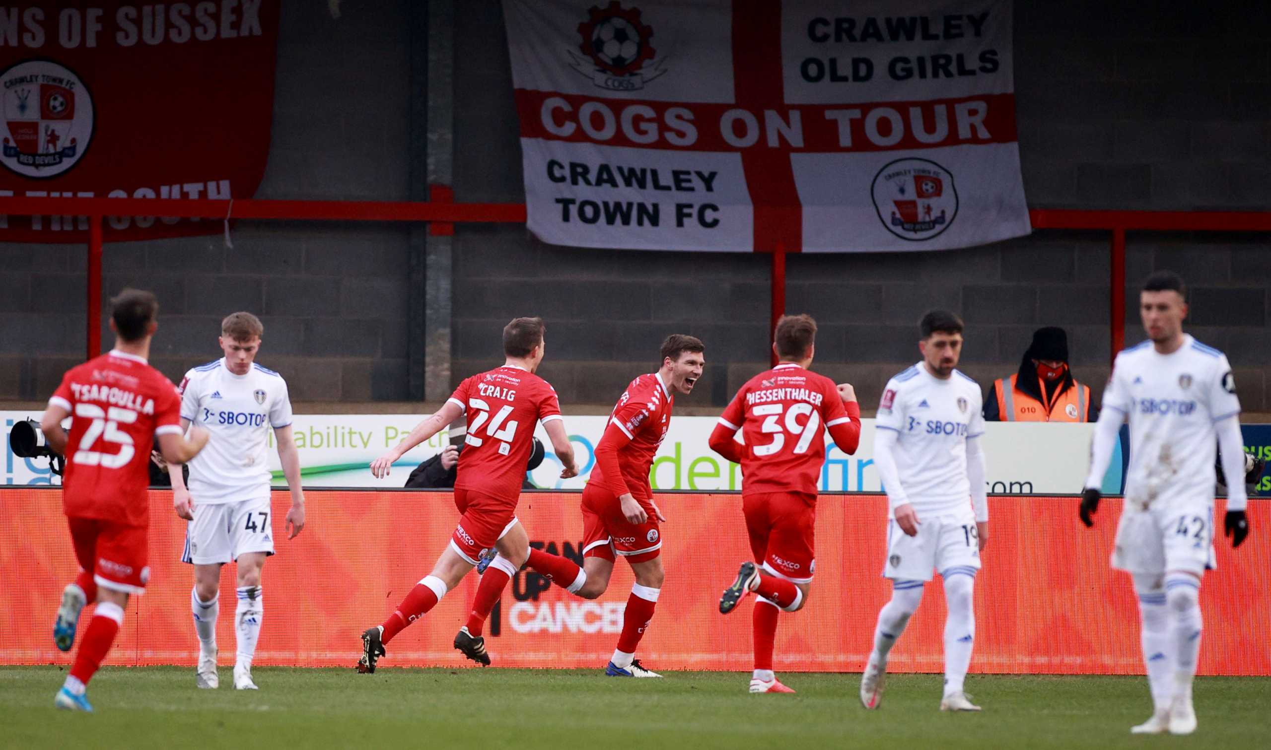 Soccer Football - FA Cup - Third Round - Crawley Town v Leeds United - The People's Pension Stadium, Crawley, Britain - January 10, 2021 Crawley Town's Jordan Tunnicliffe celebrates scoring their third goal with teammates REUTERS