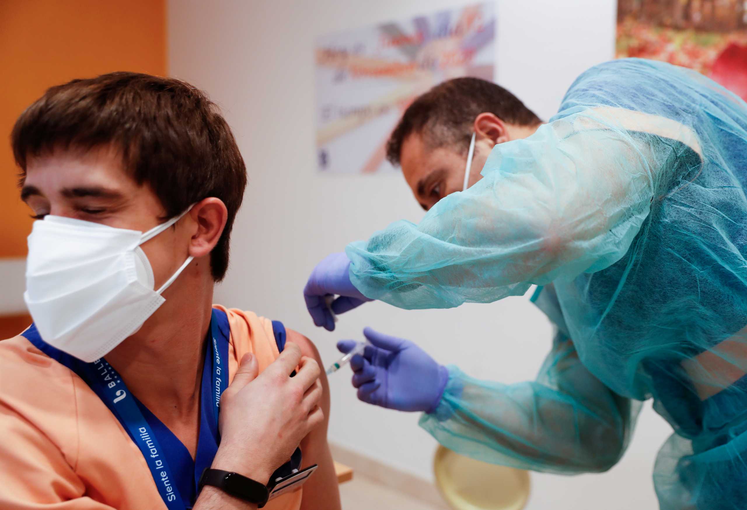 FILE PHOTO: Hernando Valiente, worker at the elderly home Ballesol, receives the second dose of the Pfizer-BioNTech COVID-19 vaccine, as the coronavirus disease (COVID-19) outbreak continues, in Madrid, Spain January 25, 2021. REUTERS