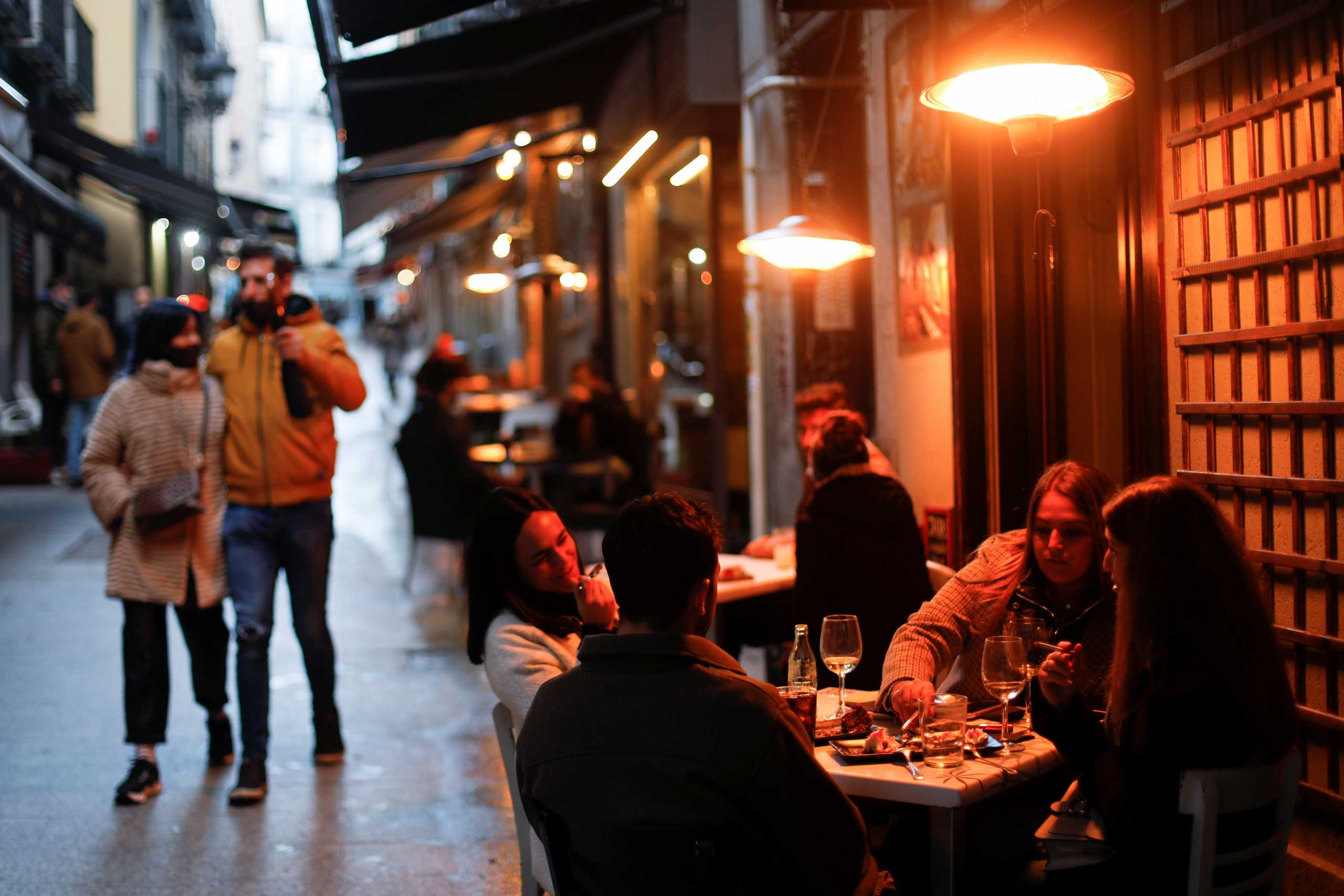 People sit at an outdoor terrace amid the coronavirus disease (COVID-19) outbreak, in Madrid, Spain January 22, 2021. REUTERS