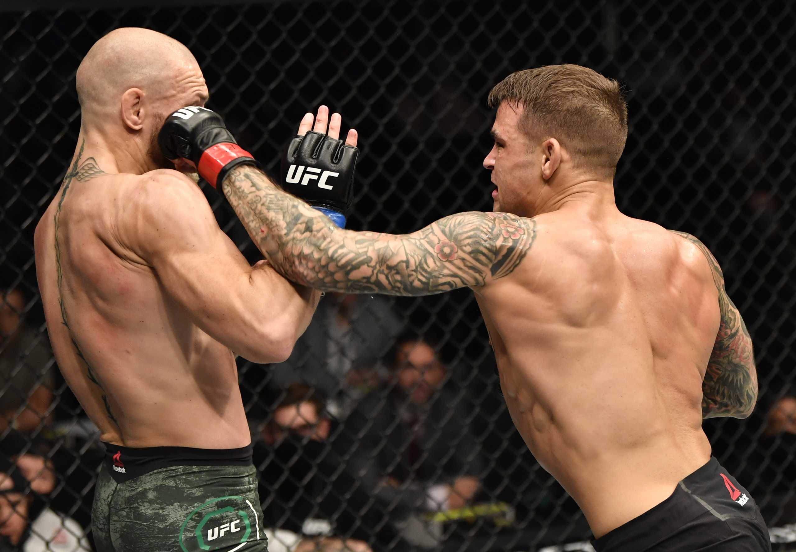 Jan 23, 2021; Abu Dhabi, United Arab Emirates; Dustin Poirier punches Conor McGregor of Ireland in a lightweight fight during the UFC 257 event inside Etihad Arena on UFC Fight Island.  Mandatory Credit: Jeff Bottari
