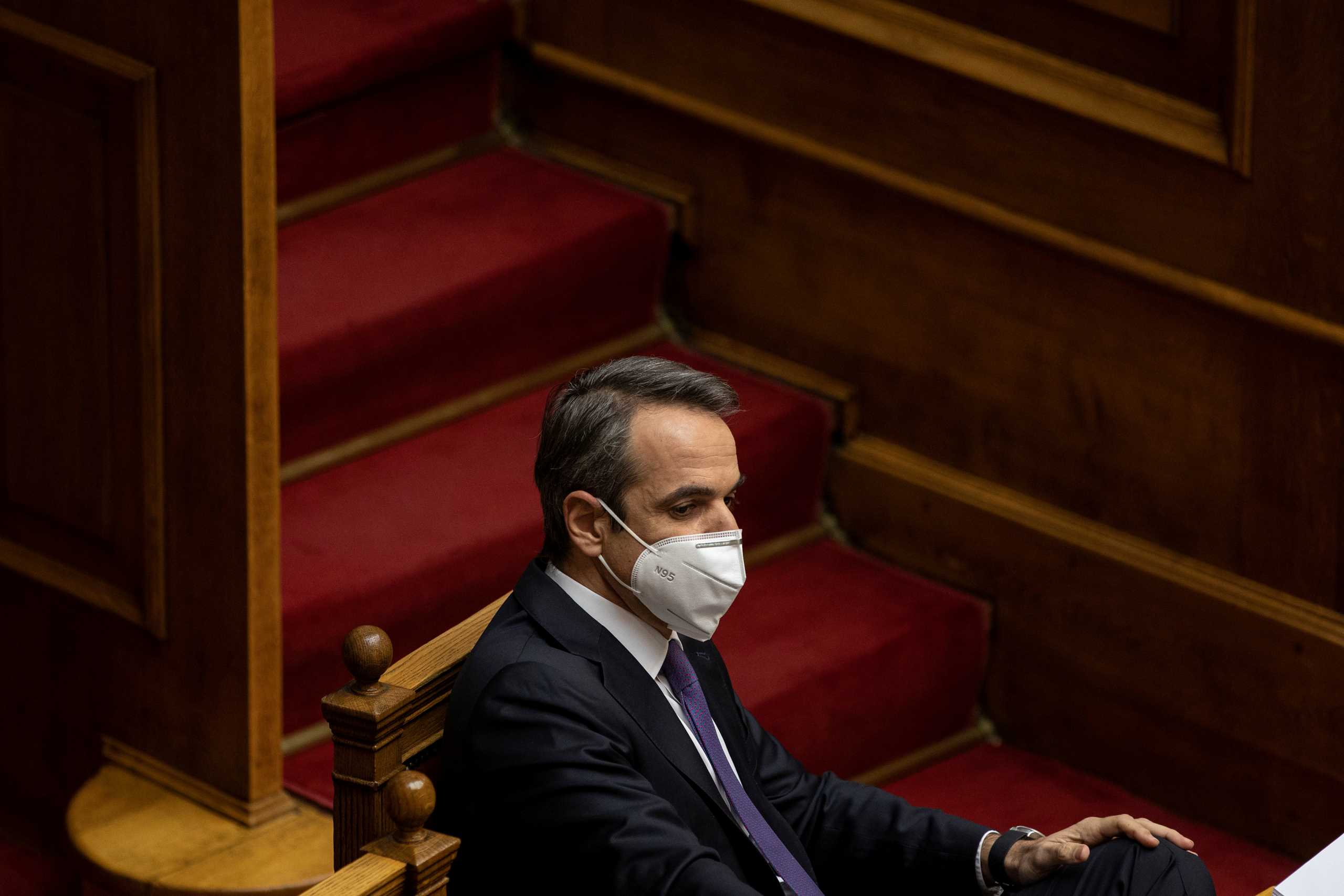 Greek Prime Minister Kyriakos Mitsotakis wears a protective face mask during a parliamentary session on the government's handling of the coronavirus disease (COVID-19) pandemic, in Athens, Greece, January 15, 2021. REUTERS
