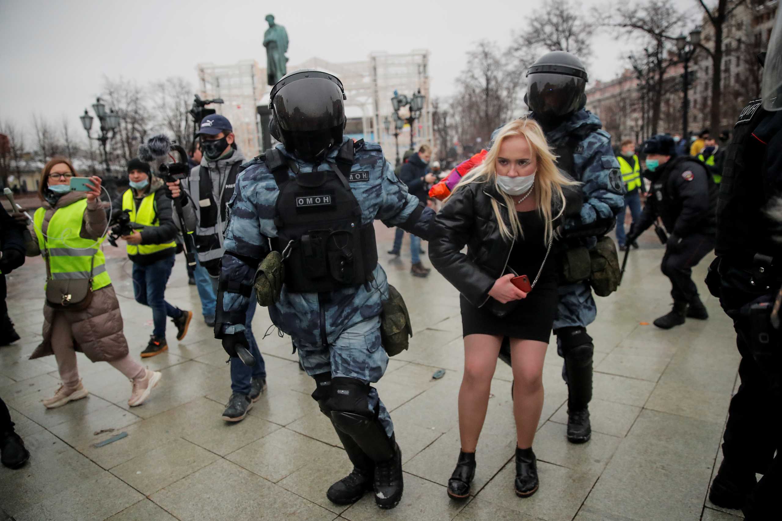 Law enforcement officers detain a woman during a rally in support of jailed Russian opposition leader Alexei Navalny in Moscow, Russia January 23, 2021. REUTERS