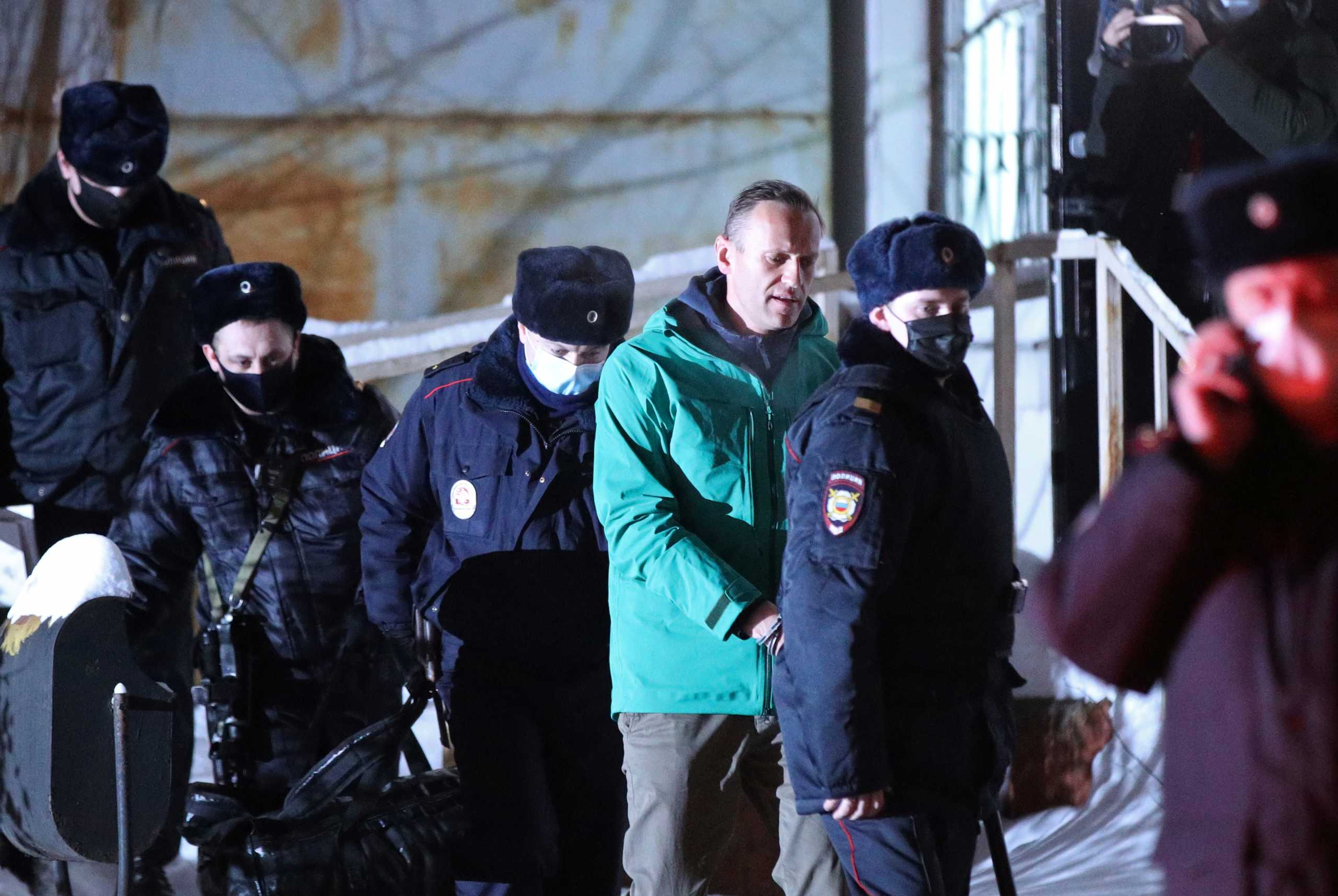 Russian opposition leader Alexei Navalny is escorted by police officers after a court hearing, in Khimki outside Moscow, Russia January 18, 2021. Evgeny Feldman
