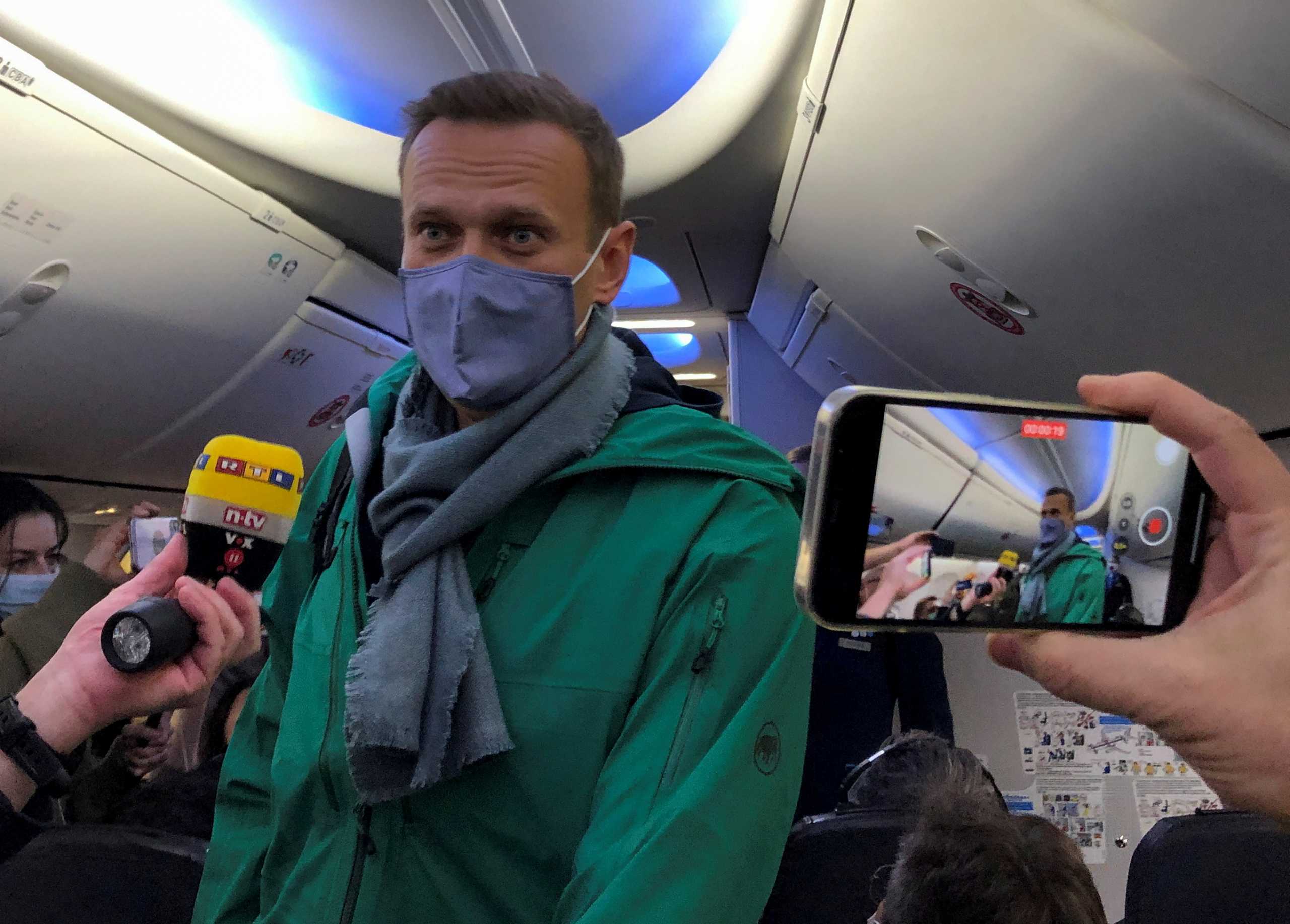 Russian opposition leader Alexei Navalny is seen on board a plane before the departure for the Russian capital Moscow at an airport in Berlin, Germany January 17, 2021. REUTERS