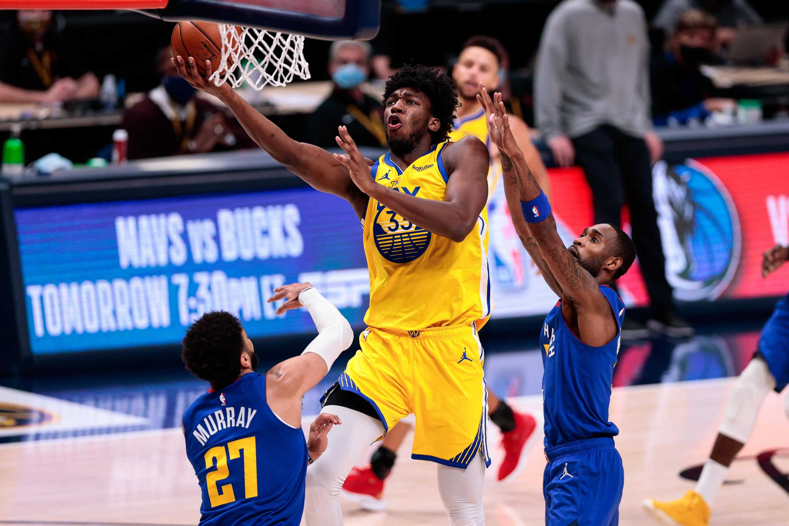 Jan 14, 2021; Denver, Colorado, USA; Golden State Warriors center James Wiseman (33) drives to the net against Denver Nuggets forward Will Barton III (5) and guard Jamal Murray (27) in the fourth quarter at Ball Arena. Mandatory Credit: Isaiah J. Downing-USA TODAY Sports