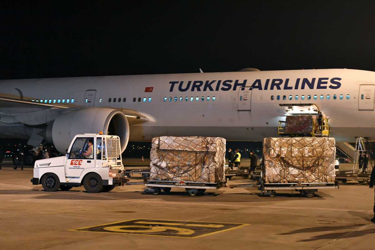 Workers unload a shipment containing boxes of China's Sinovac coronavirus disease (COVID-19) vaccine at Esenboga Airport in Ankara, Turkey, December 30, 2020. REUTERS