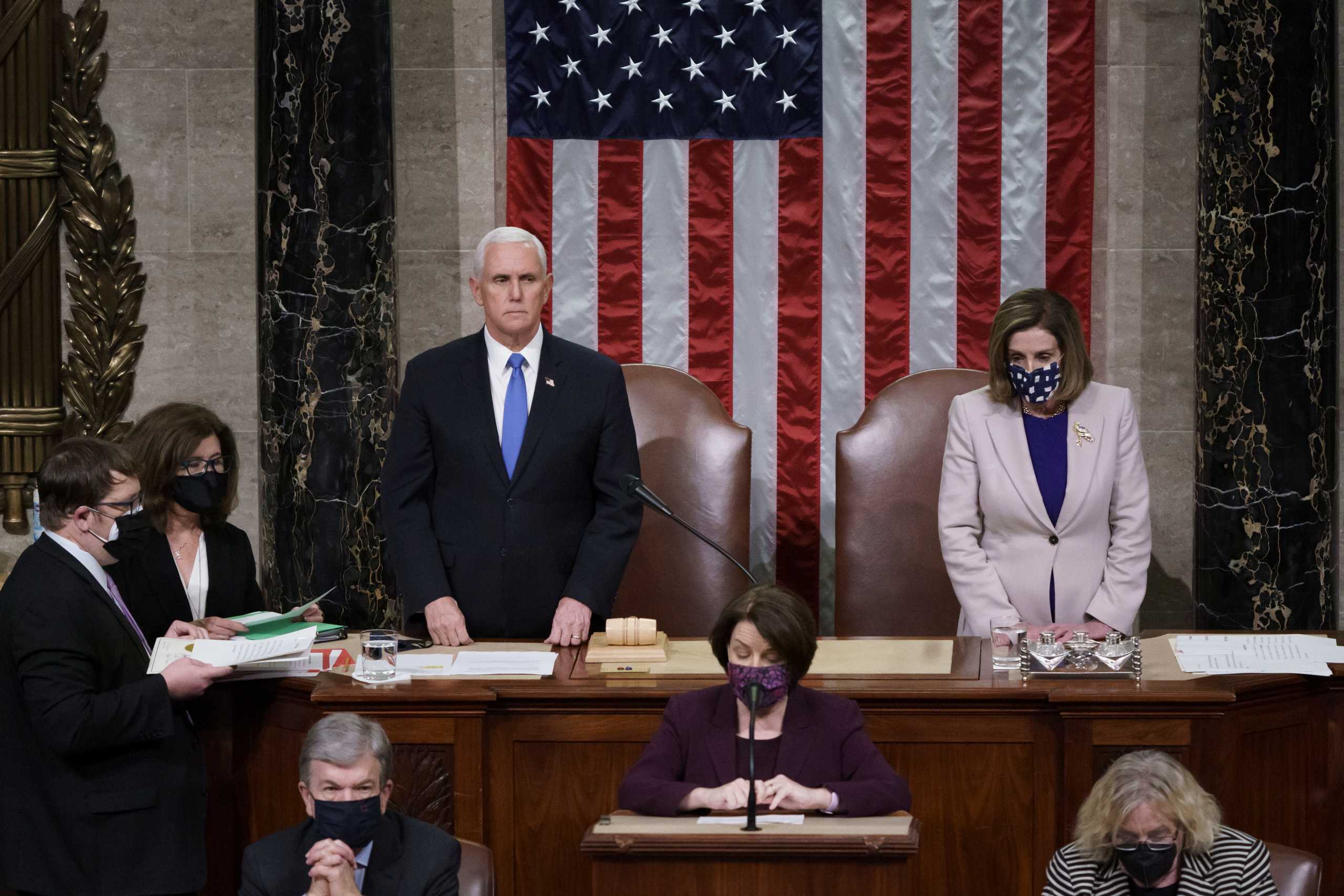 U.S. Vice President Mike Pence and Speaker of the House Nancy Pelosi (D-CA), read the final certification of Electoral College votes cast in November's presidential election during a joint session of Congress after working through the night, at the Capitol in Washington, U.S., January 7, 2021. Protesters loyal to President Donald Trump stormed the Capitol Wednesday, disrupting the process. J. Scott Applewhite