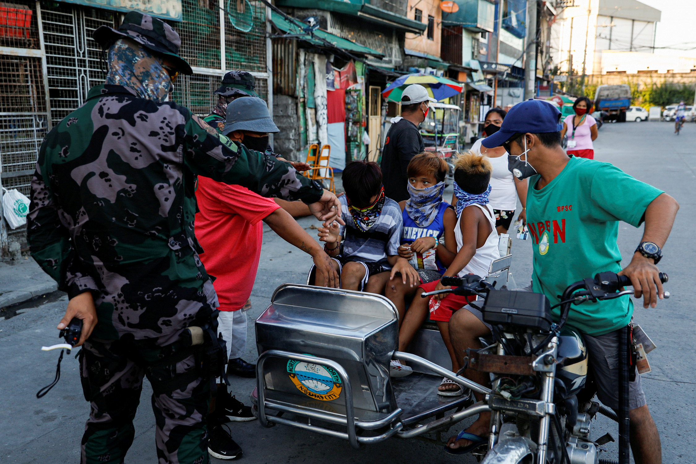 FILE PHOTO: Children whom authorities say violated quarantine restrictions, board a rickshaw to go to a local government hall for a lecture on safety precautions against coronavirus disease (COVID-19), in Navotas, Metro Manila, Philippines, July 16, 2020. Picture taken July 16, 2020. REUTERS