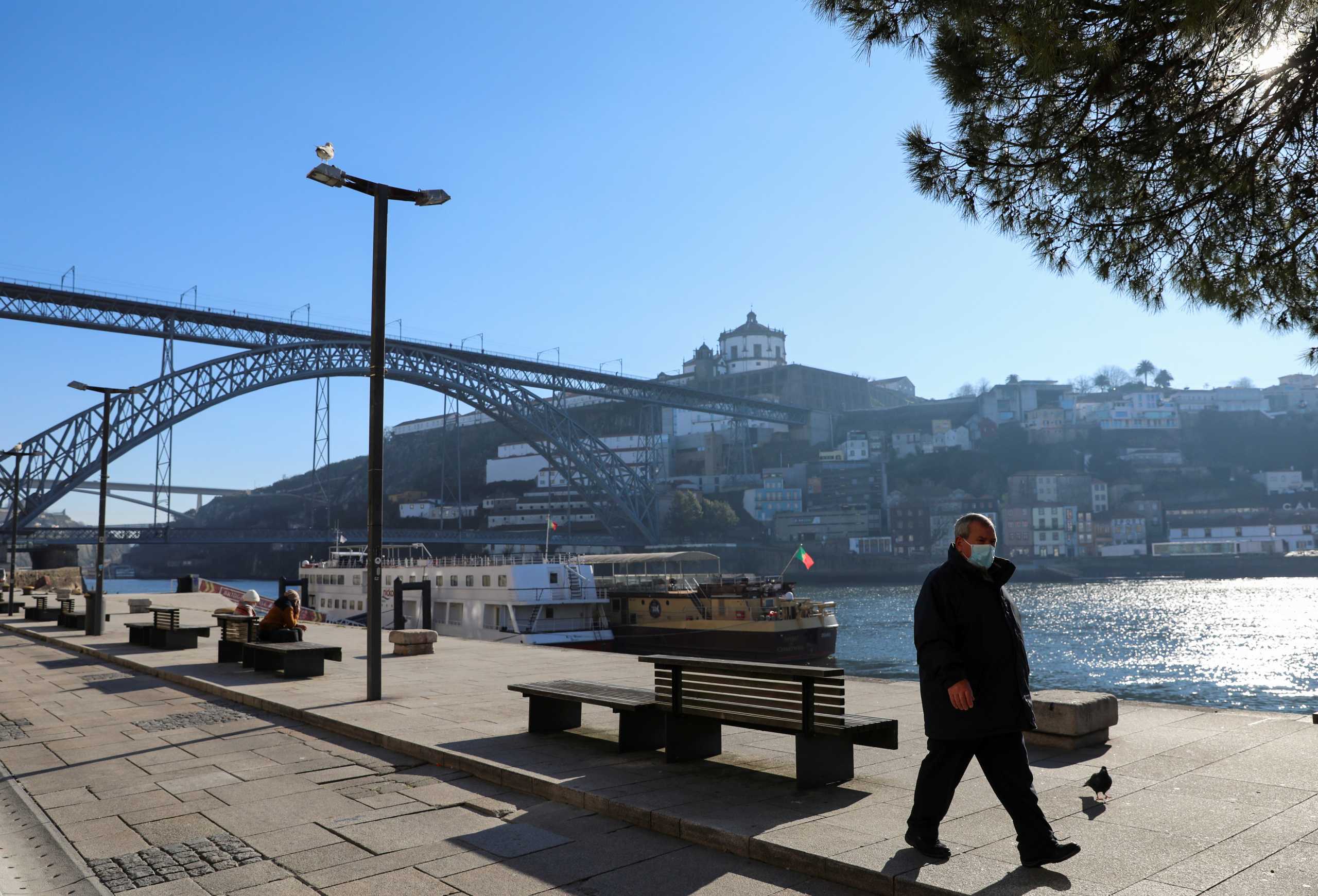 A man walks during a lockdown following a soaring of coronavirus disease (COVID-19) in Porto, Portugal January 18, 2021. REUTERS