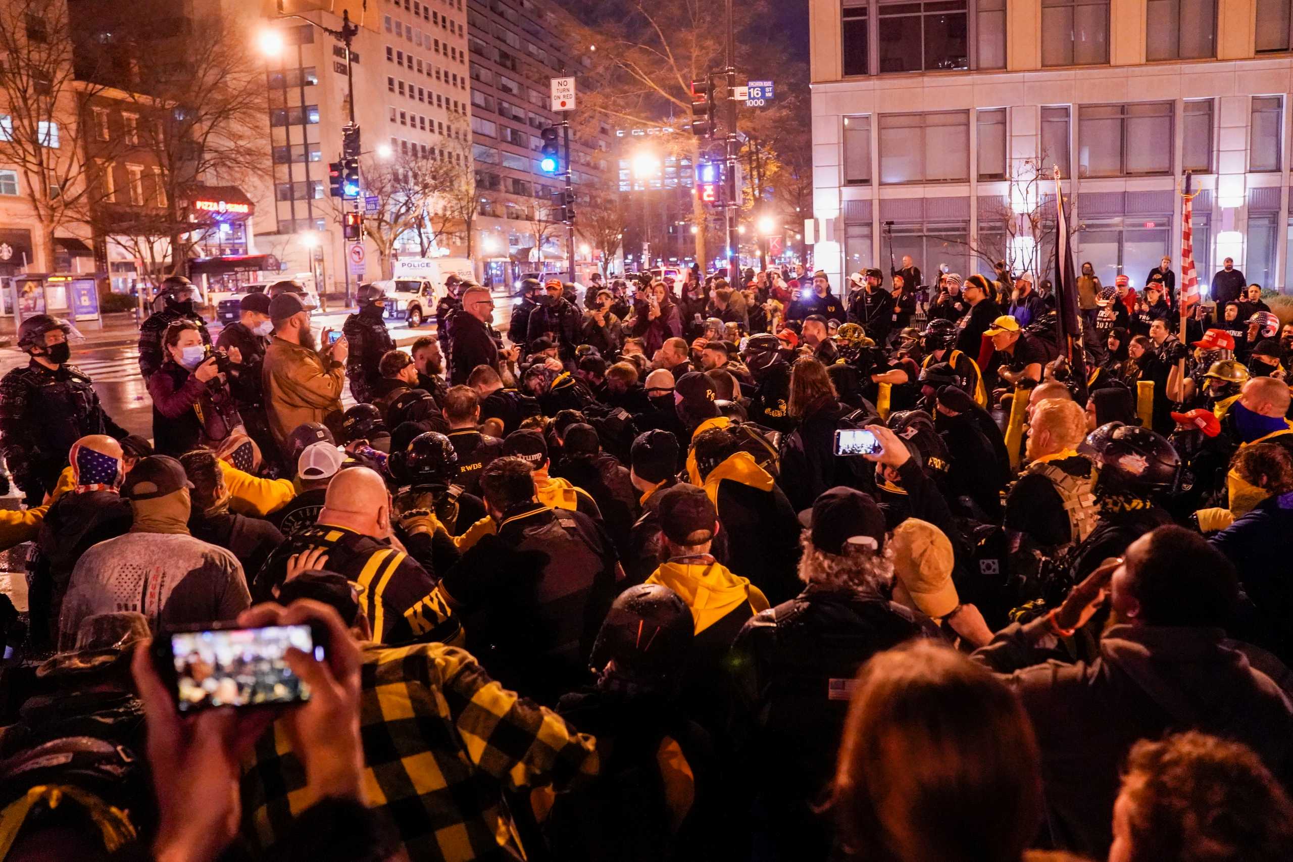 Members of the far-right group Proud Boys kneel as they gather near Black Lives Matter Plaza in Washington, U.S., December 12, 2020. REUTERS