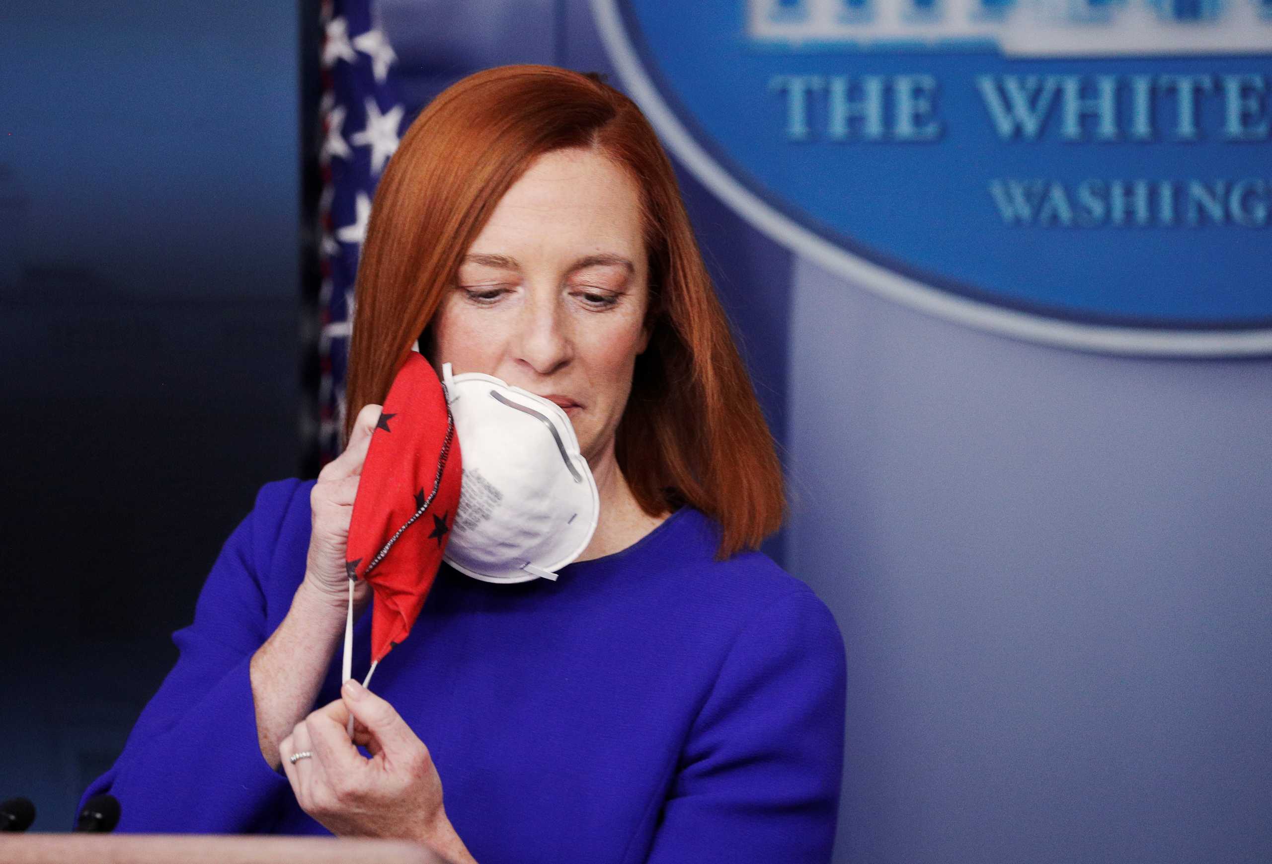 White House Press Secretary Jen Psaki removes her face mask before speaking in the James S Brady Press Briefing Room at the White House, after the inauguration of Joe Biden as the 46th President of the United States, U.S., January 20, 2021. REUTERS
