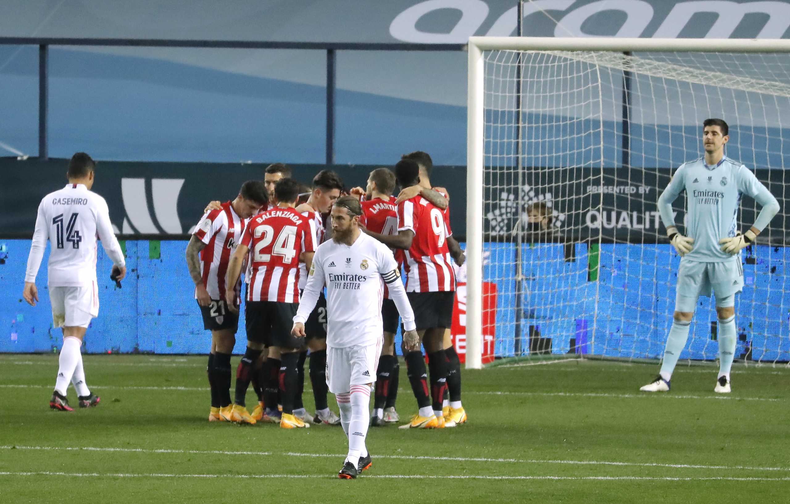 Soccer Football - Spanish Super Cup - Semi Final - Real Madrid v Athletic Bilbao - La Rosaleda Stadium, Malaga, Spain - January 14, 2021 Real Madrid's Sergio Ramos looks dejected as Athletic Bilbao's Raul Garcia celebrates scoring their first goal with teammates REUTERS