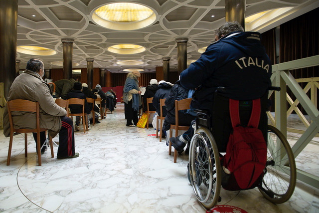 A group of homeless people who are looked after in structures run by the office of papal charities, wait to receive their first dose of the vaccine against the coronavirus disease (COVID-19), at the Vatican, January 20, 2021. Vatican Media