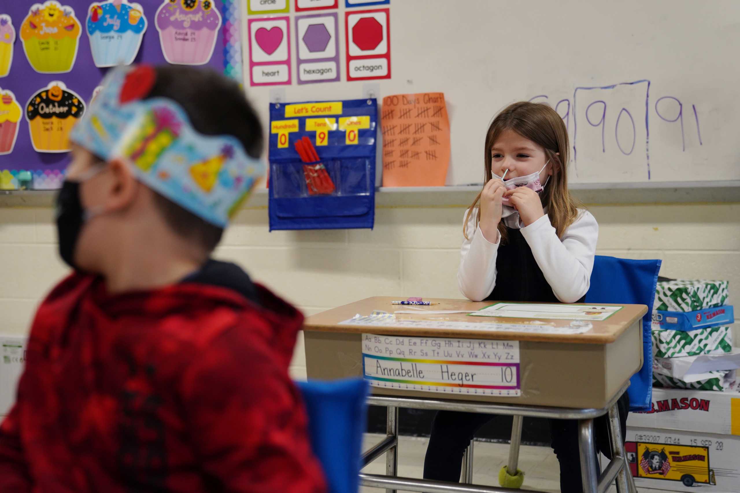Schoolchildren swab and test themselves for COVID-19 to prevent the spread of the coronavirus disease (COVID-19) in the classroom at South Boston Catholic Academy in Boston, Massachusetts, U.S., January 28, 2021.  REUTERS