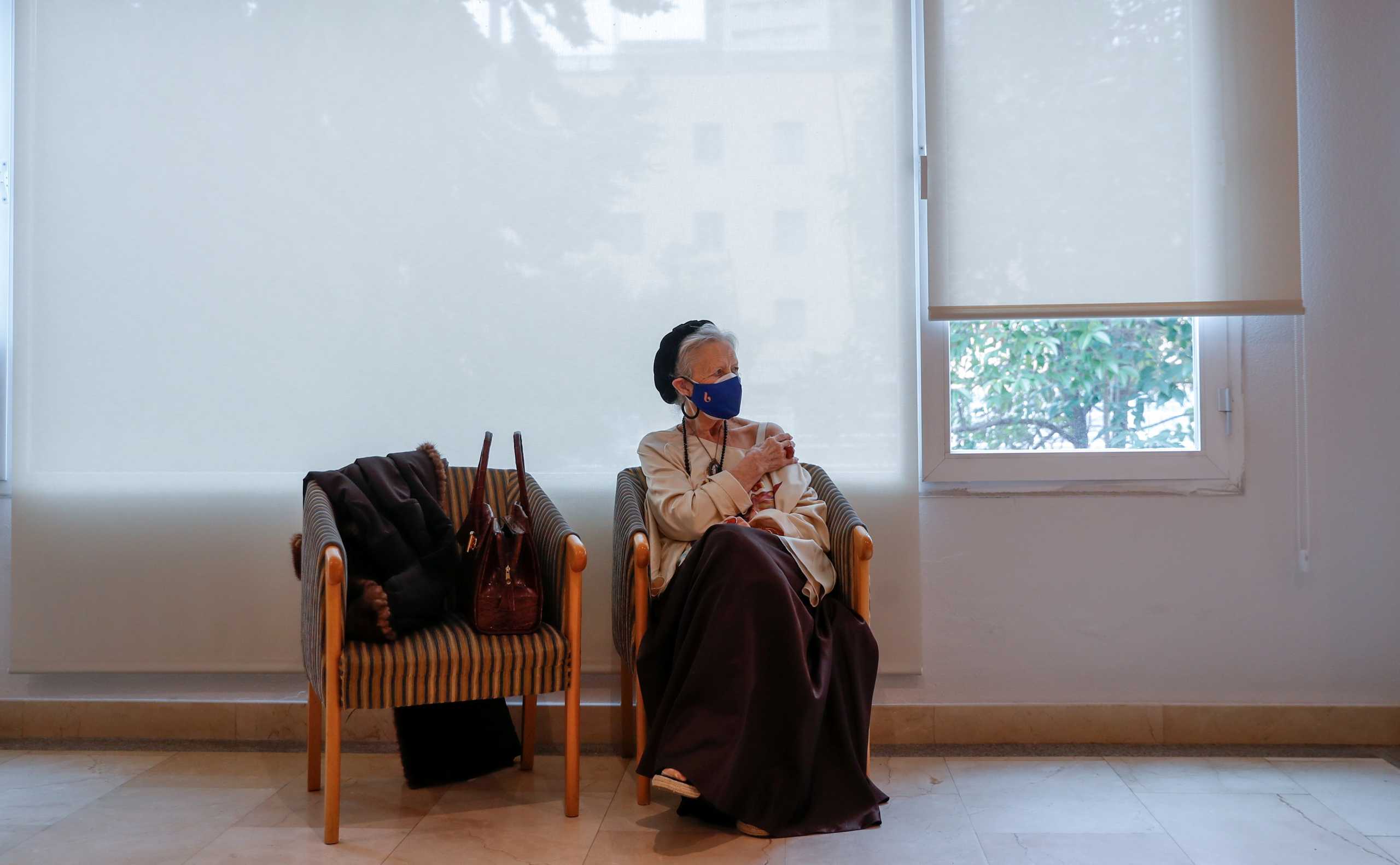 Pilar Mazas, 90, resident at the elderly home Ballesol, sits after receiving the second dose of the Pfizer-BioNTech COVID-19 vaccine, as the coronavirus disease (COVID-19) outbreak continues, in Madrid, Spain January 25, 2021. REUTERS