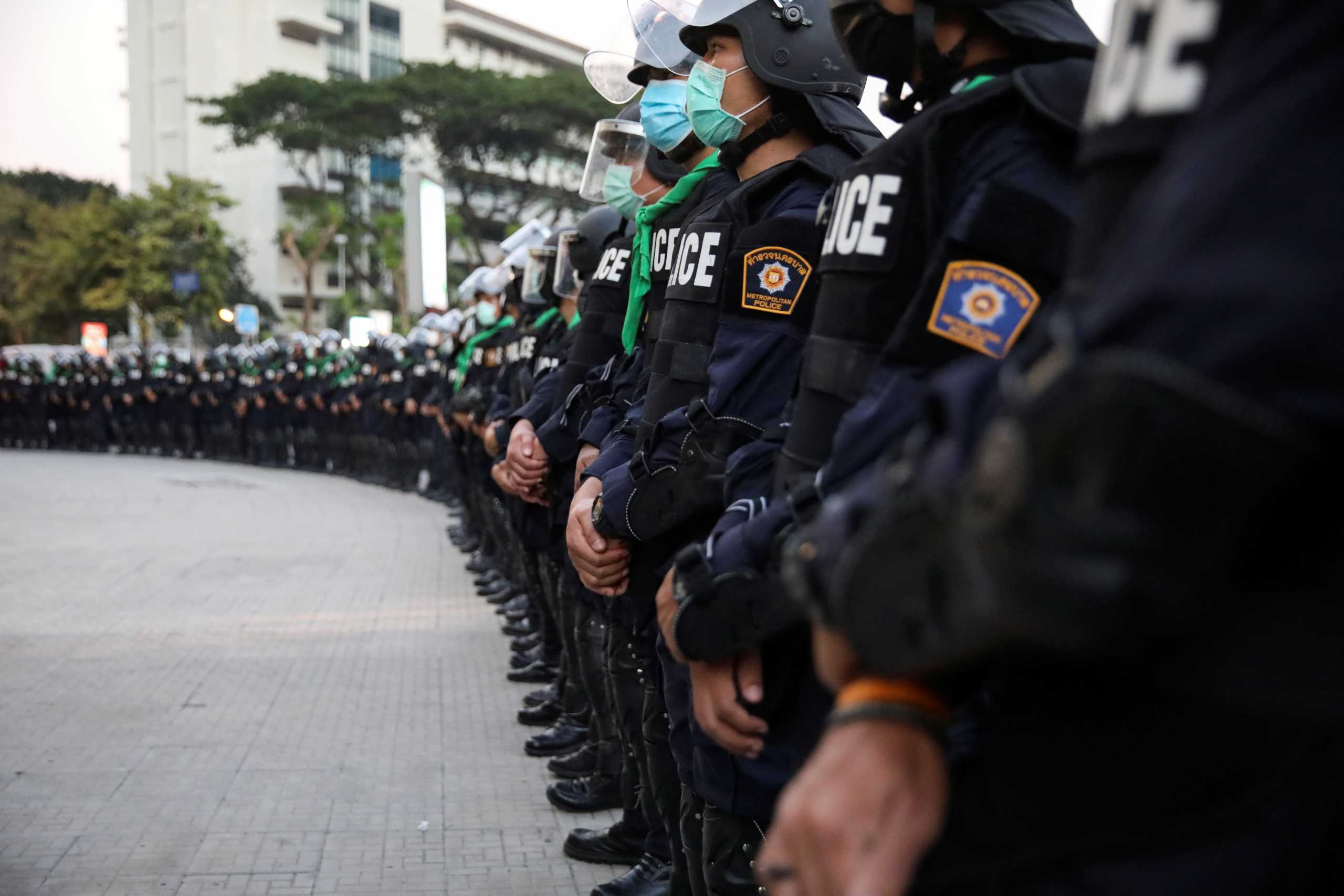 Police officers stand guard during a demonstration demanding to release the people arrested following the anti-government and reforming monarchy protests in Bangkok, Thailand, January 16, 2021. REUTERS