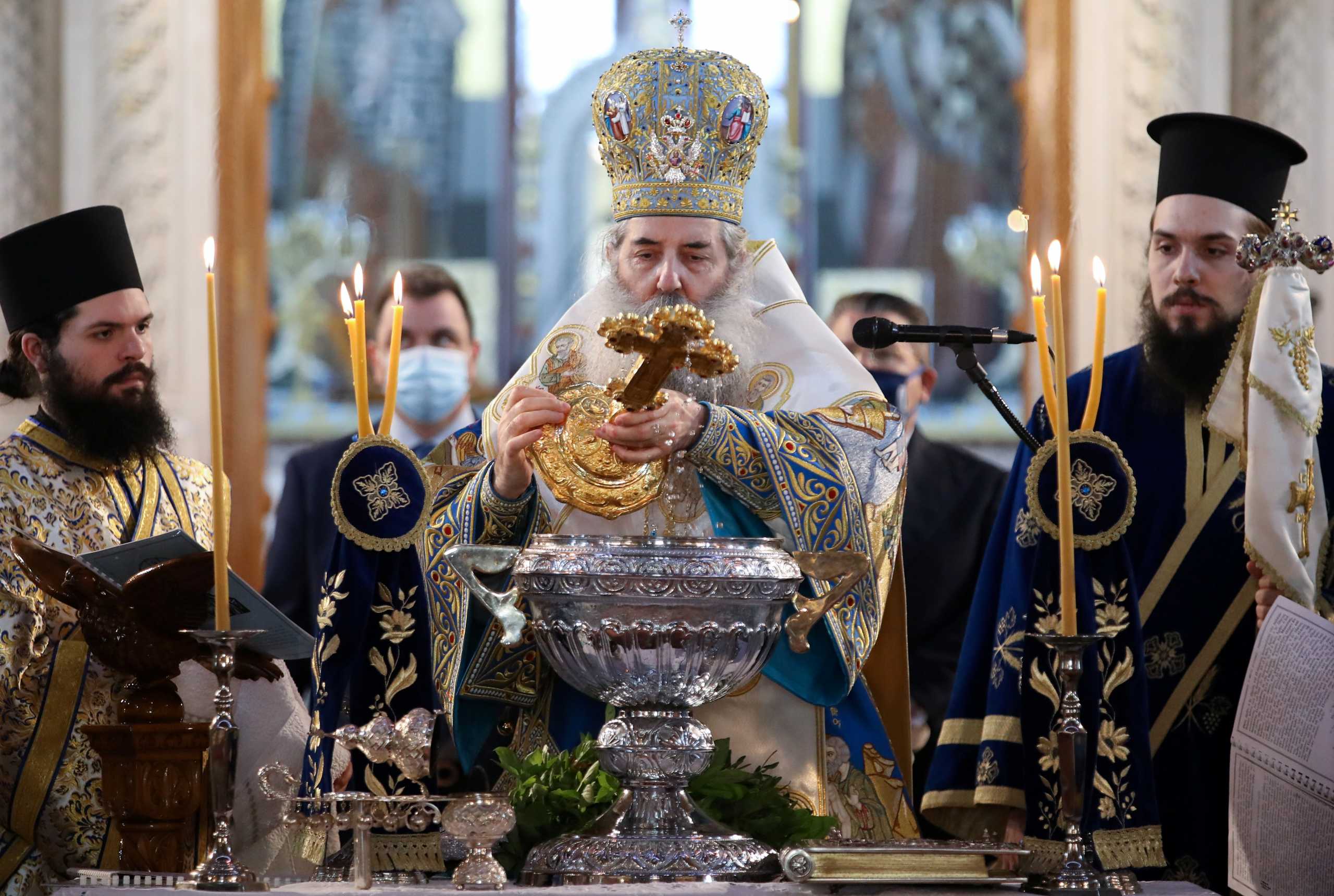 Metropolitan of Piraeus Seraphim immerses a cross into the water during a service for Orthodox Epiphany celebrations, after Holy Synod rejected government decision to close churches on Epiphany day, amid the coronavirus disease (COVID-19) pandemic, in Piraeus, Greece January 6, 2021. REUTERS