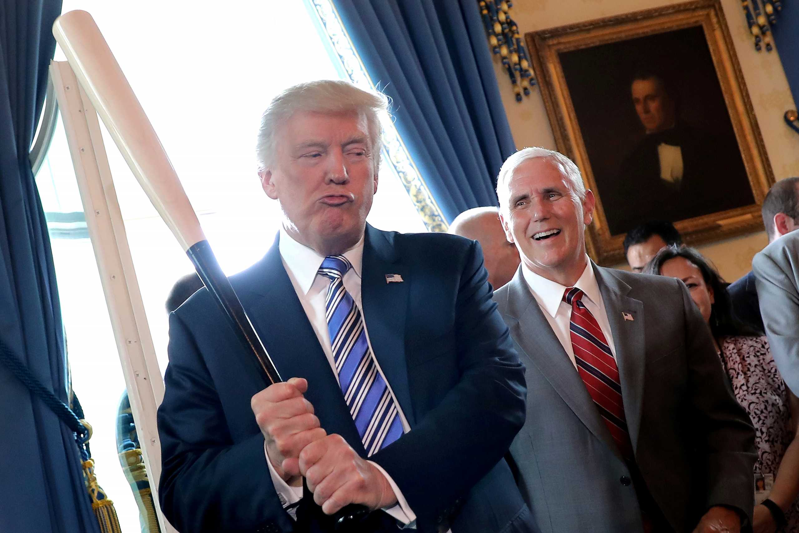 FILE PHOTO: FILE PHOTO: Vice President Mike Pence laughs as President Donald Trump holds a baseball bat as they attend a Made in America product showcase event at the White House in Washington, July 17, 2017. REUTERS