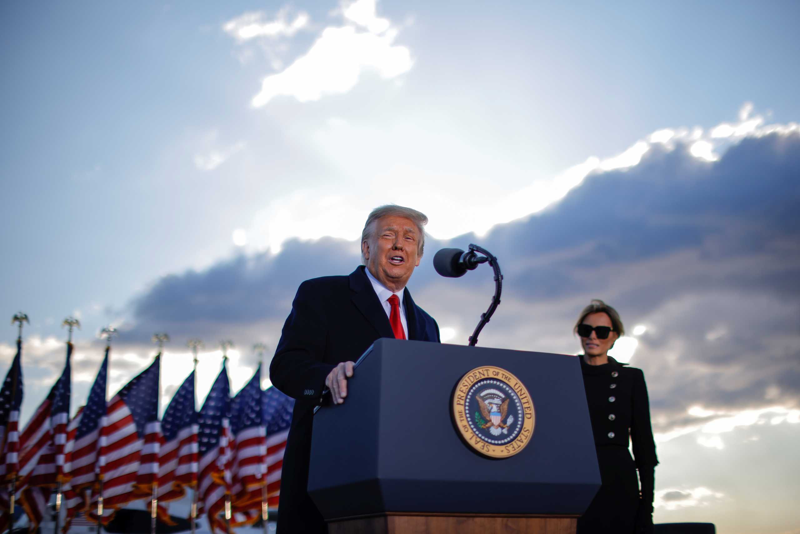 U.S. President Donald Trump speaks next to first lady Melania Trump as he departs from the Joint Base Andrews, Maryland, U.S., January 20, 2021. REUTERS