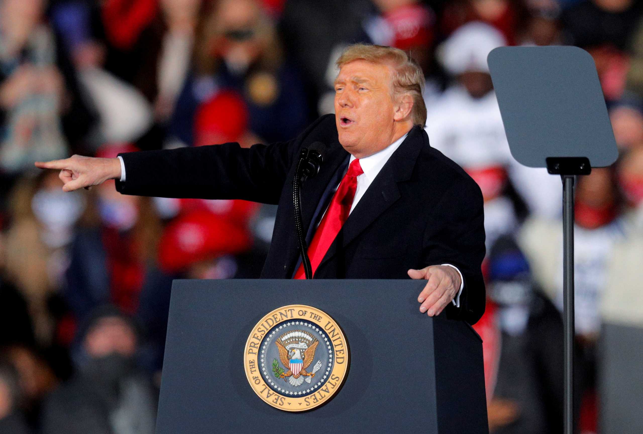 FILE PHOTO: U.S. President Donald Trump gestures while campaigning for Republican Senator Kelly Loeffler on the eve of the run-off election to decide both of Georgia's Senate seats, in Dalton, Georgia, U.S., January 4, 2021. REUTERS