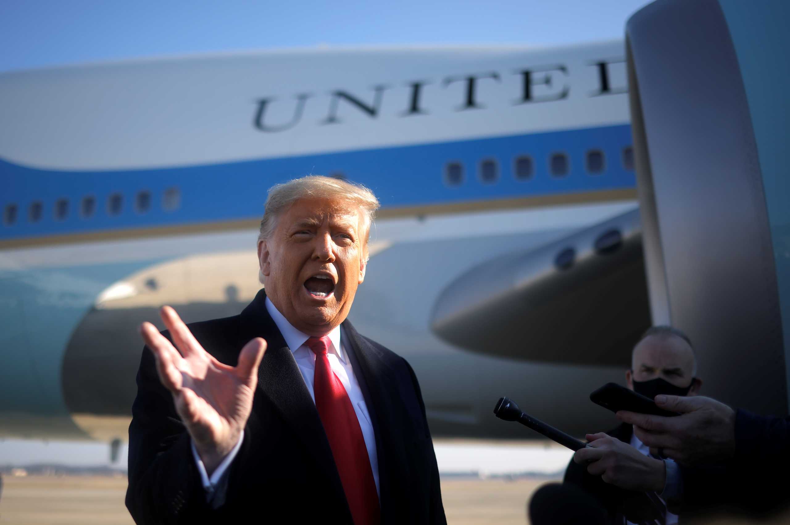 U.S. President Donald Trump speaks to the media before boarding Air Force One to depart Washington on travel to visit the U.S.-Mexico border Wall in Texas, at Joint Base Andrews in Maryland, U.S., January 12, 2021. REUTERS