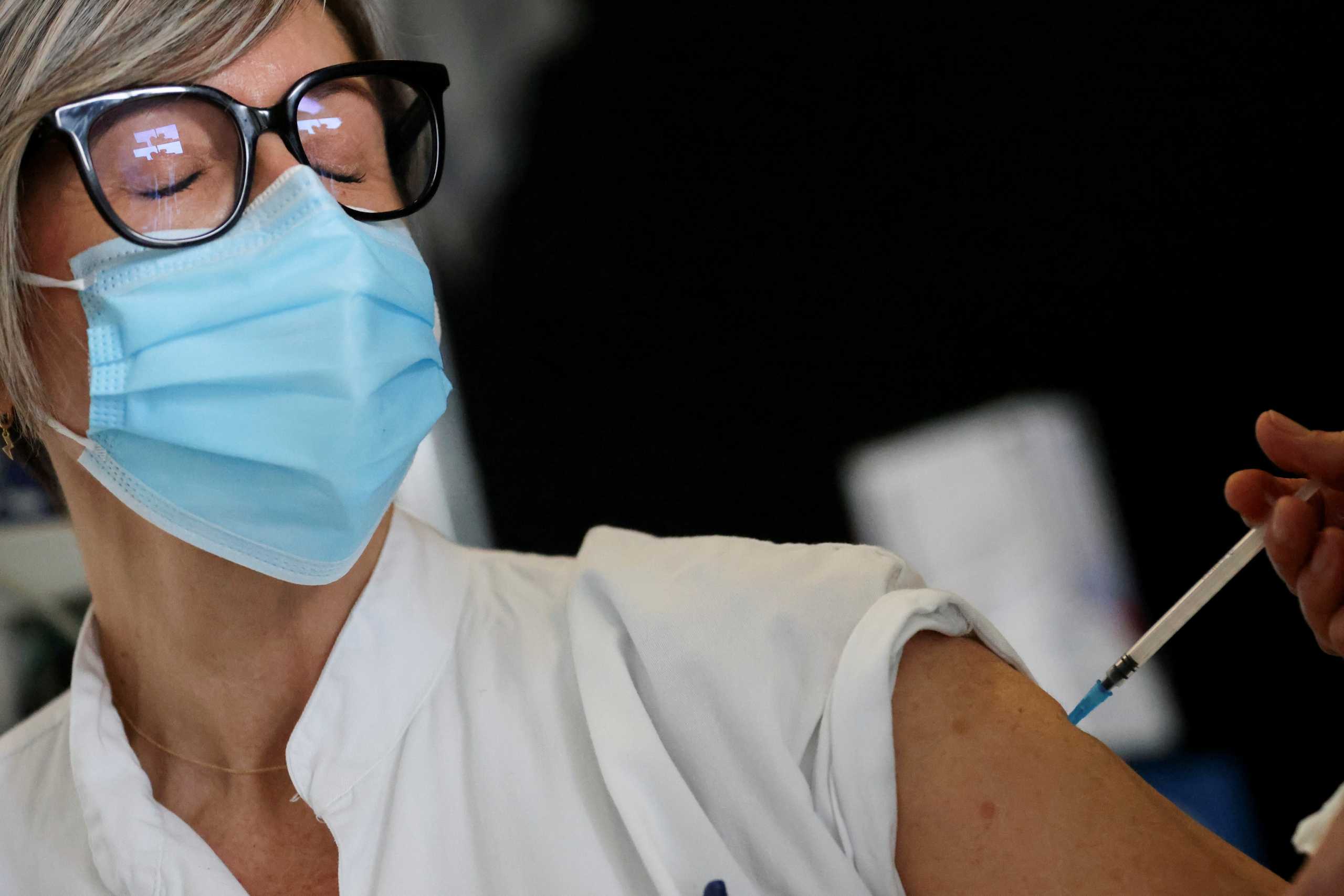 A healthcare worker receives a second dose of the Pfizer-BioNTech coronavirus disease (COVID-19) vaccine, at Sant Pau hospital, in Barcelona, Spain January 28, 2021. REUTERS