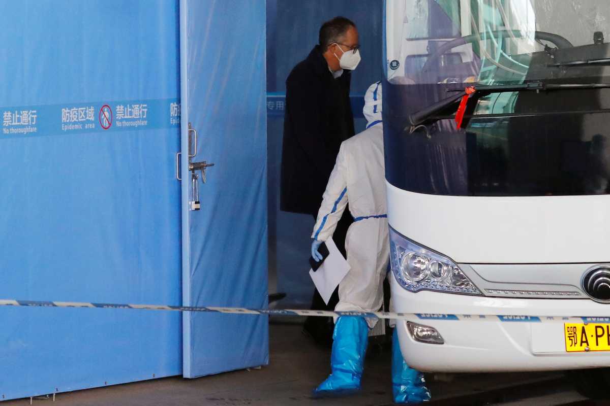 A member of the World Health Organisation (WHO) team tasked with investigating the origins of the coronavirus disease (COVID-19) pandemic boards a bus before leaving Wuhan Tianhe International Airport in Wuhan, Hubei province, China January 14, 2021. REUTERS