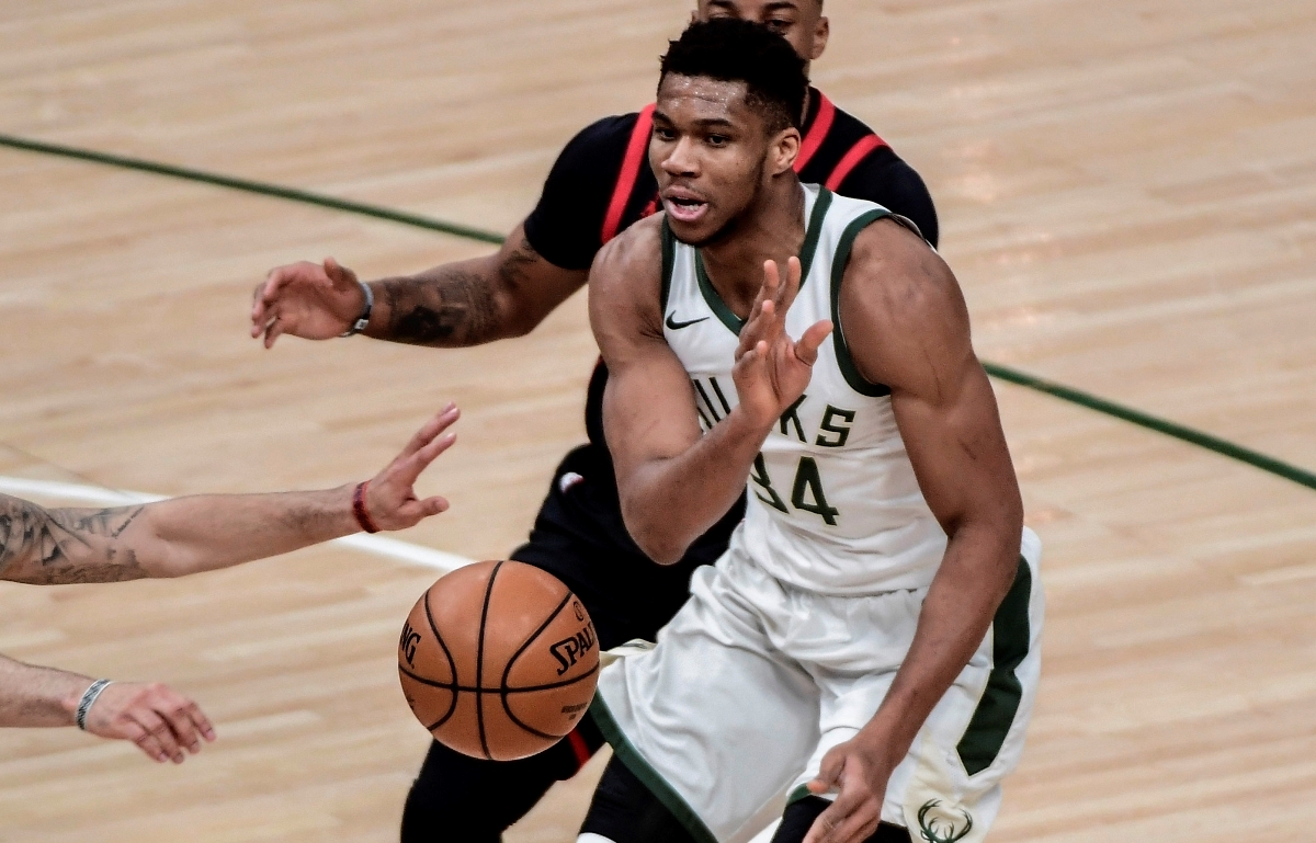 Feb 16, 2021; Milwaukee, Wisconsin, USA; Milwaukee Bucks forward Giannis Antetokounmpo (34) passes the ball away from Toronto Raptors guard Fred VanVleet (23) in the third quarter at Fiserv Forum. Mandatory Credit: Benny Sieu-USA TODAY Sports