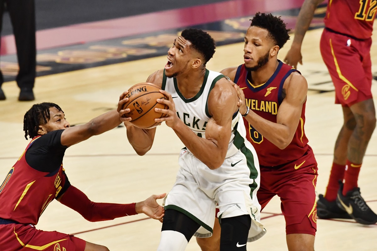 Feb 5, 2021; Cleveland, Ohio, USA; Milwaukee Bucks forward Giannis Antetokounmpo (34) drives to the basket between Cleveland Cavaliers guard Darius Garland (10) and forward Lamar Stevens (8) during the third quarter at Rocket Mortgage FieldHouse. Mandatory Credit: Ken Blaze-USA TODAY Sports