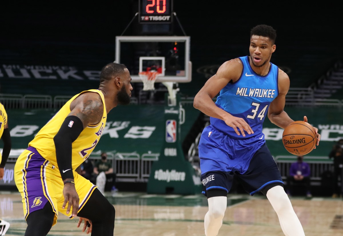 Jan 21, 2021; Milwaukee, WI, USA;  Milwaukee Bucks forward Giannis Antetokounmpo (34) is defended by Los Angeles Lakers forward LeBron James (23) at the Bradley Center.  Mandatory Credit: Nick Monroe