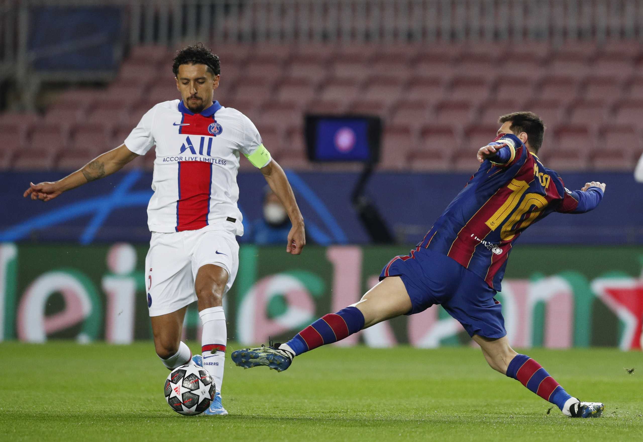 Soccer Football - Champions League - Round of 16 First Leg - FC Barcelona v Paris St Germain - Camp Nou, Barcelona, Spain - February 16, 2021  Barcelona's Lionel Messi in action with Paris St Germain's Marquinhos REUTERS