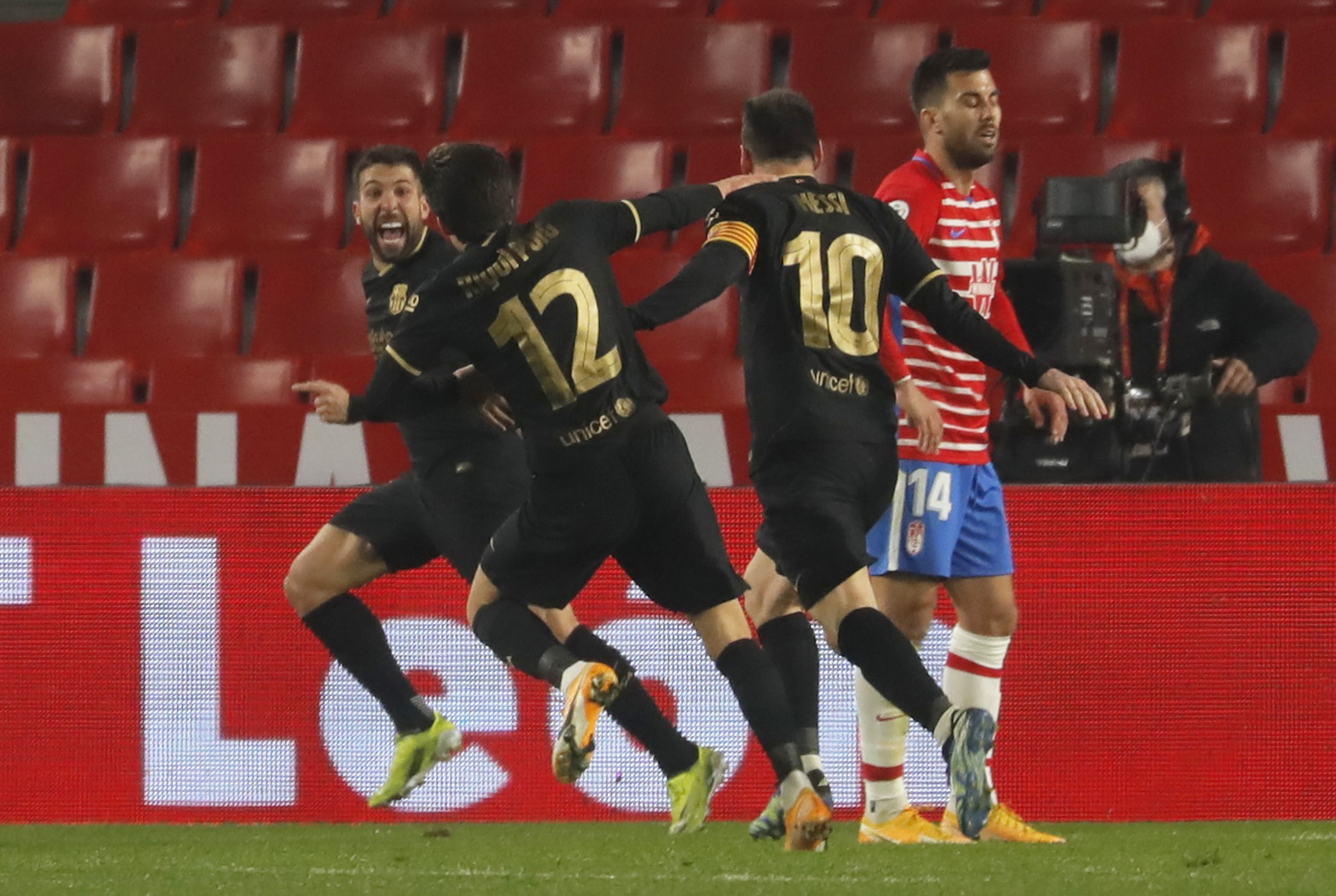 Soccer Football - Copa del Rey - Quarter Final - Granada v FC Barcelona - Nuevo Estadio de Los Carmenes, Granada, Spain - February 3, 2021 Barcelona's Jordi Alba celebrates scoring their second goal with teammates as Granada's Fede Vico looks dejected REUTERS