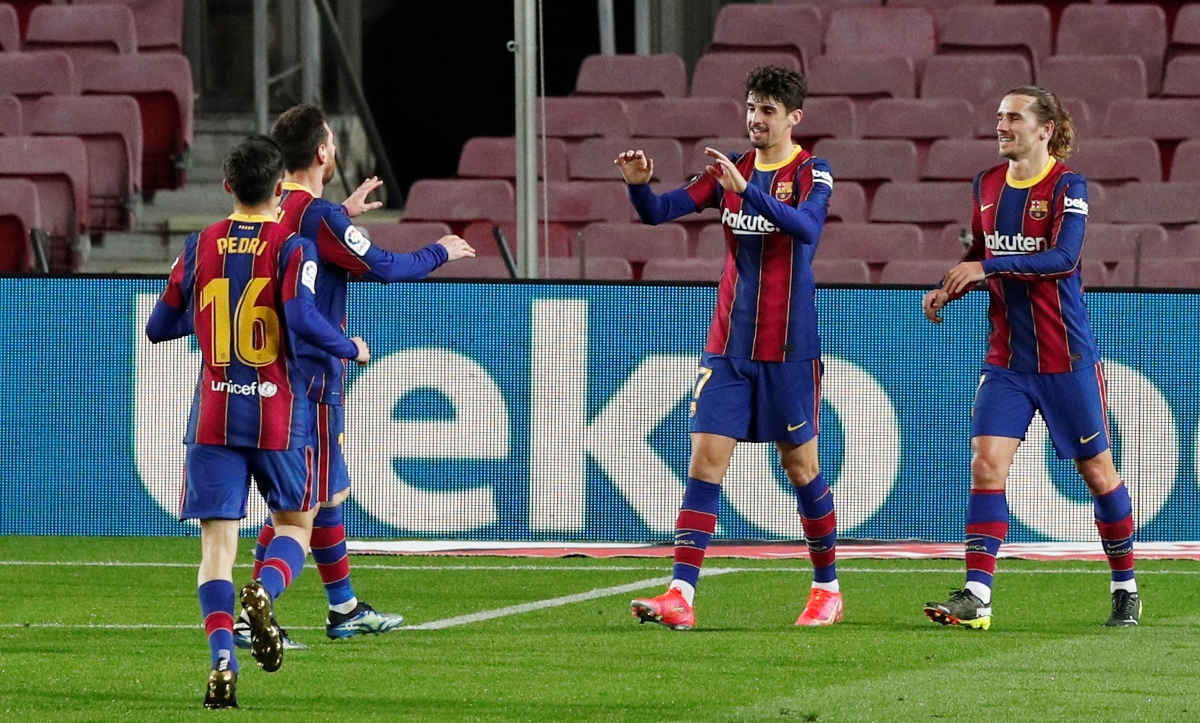 Soccer Football - La Liga Santander - FC Barcelona v Alaves - Camp Nou, Barcelona, Spain - February 13, 2021 Barcelona's Francisco Trincao celebrates scoring their third goal with teammates REUTERS