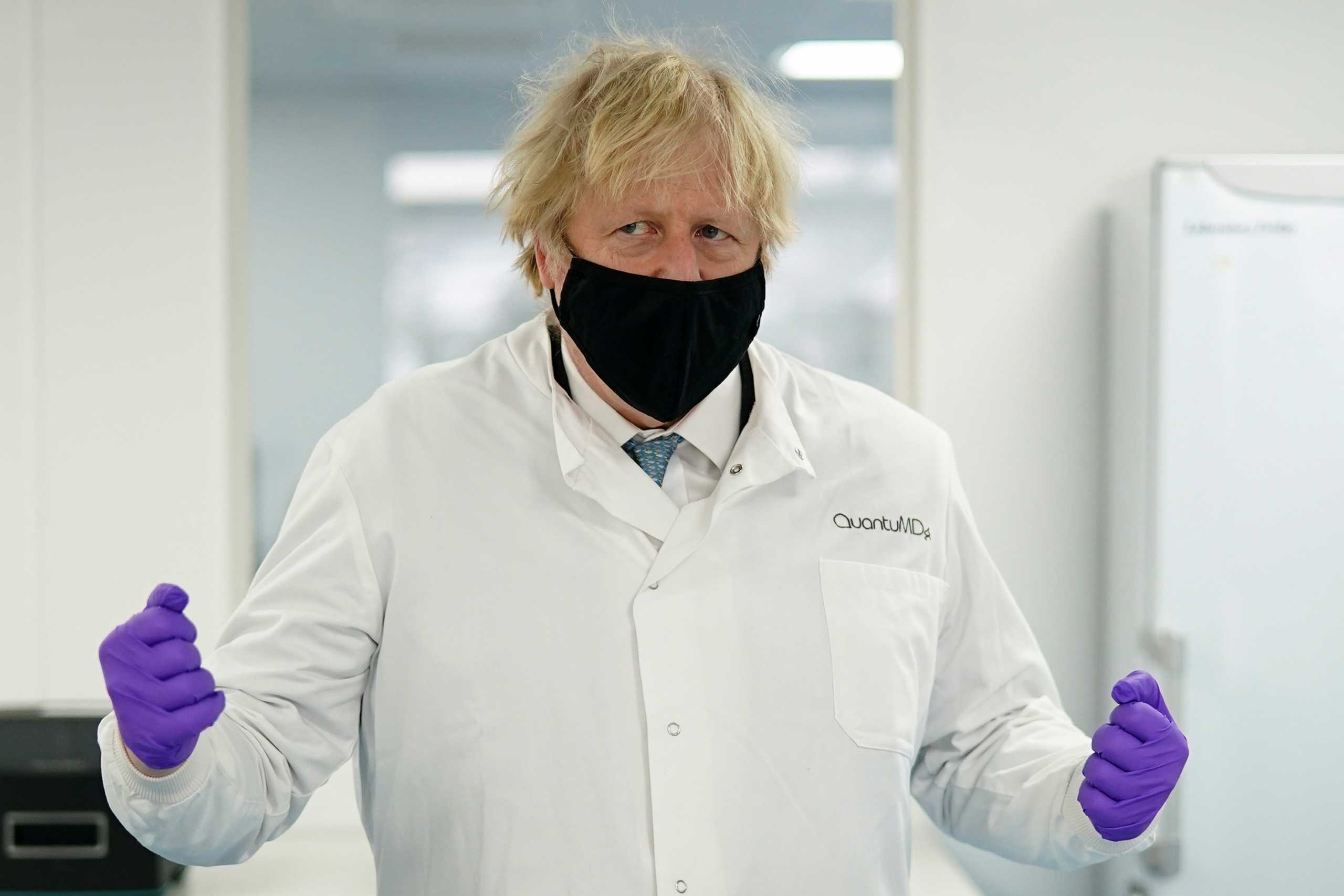 Britain's Prime Minister Boris Johnson, wearing a face mask to prevent the spread of the coronavirus disease (COVID-19), visits the QuantuMDx Biotechnology company, in Newcastle Upon Tyne, Britain, February 13, 2021. Ian Forsyth