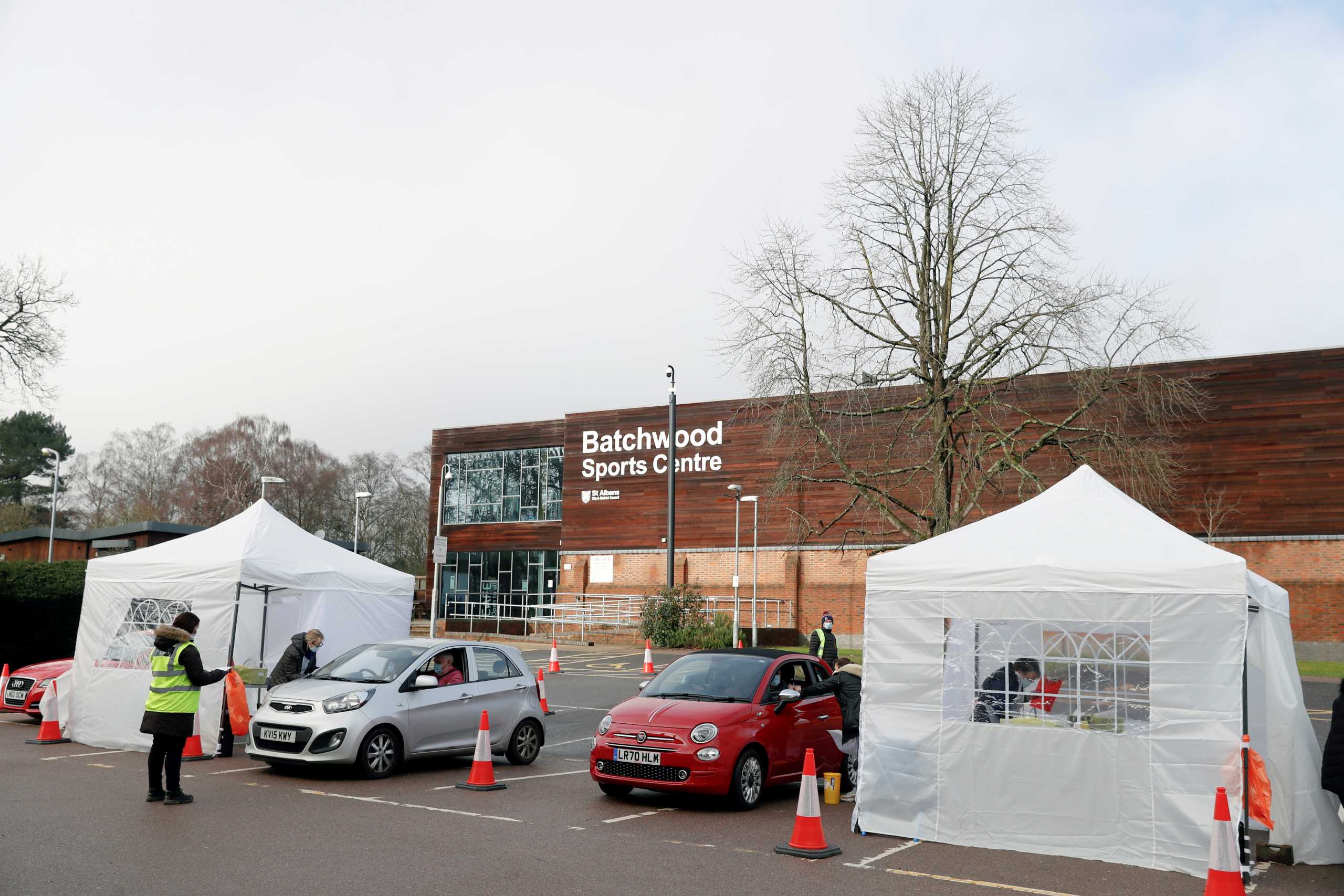 People wait to receive the COVID-19 vaccine at a drive-thru vaccination centre at Batchwood Hall, amid the outbreak of coronavirus disease (COVID-19) in St Albans, Britain, February 5, 2021. REUTERS