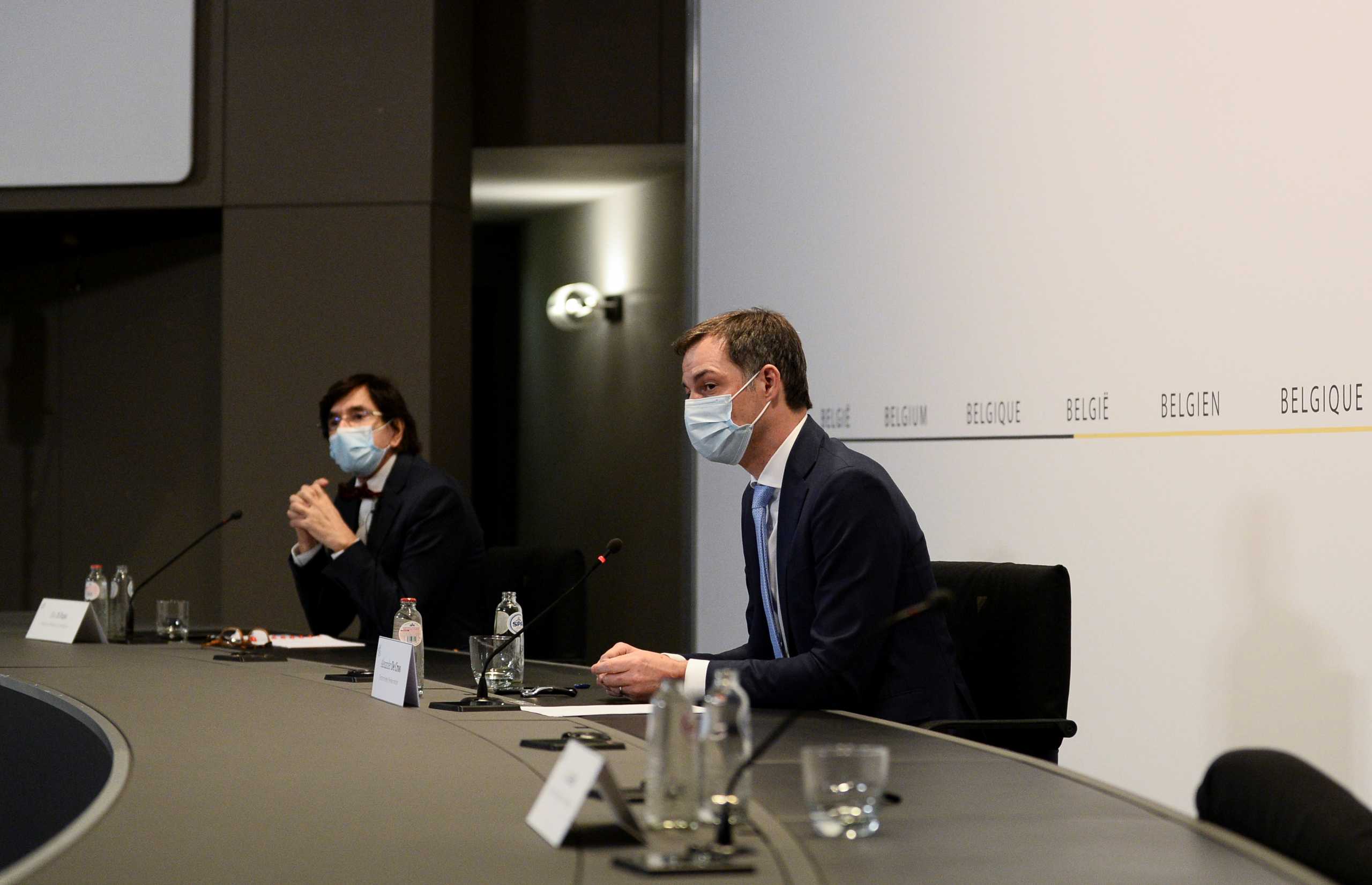 Belgian Walloon Region Minister President Elio Di Rupo and Prime Minister Alexander De Croo attend a news conference after a government meeting to announce new coronavirus disease (COVID-19) related restrictions in Brussels, Belgium February 26, 2021. REUTERS
